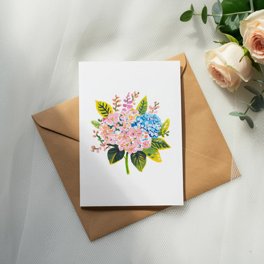 White card with floral illustration on brown envelope, with roses and eucalyptus.