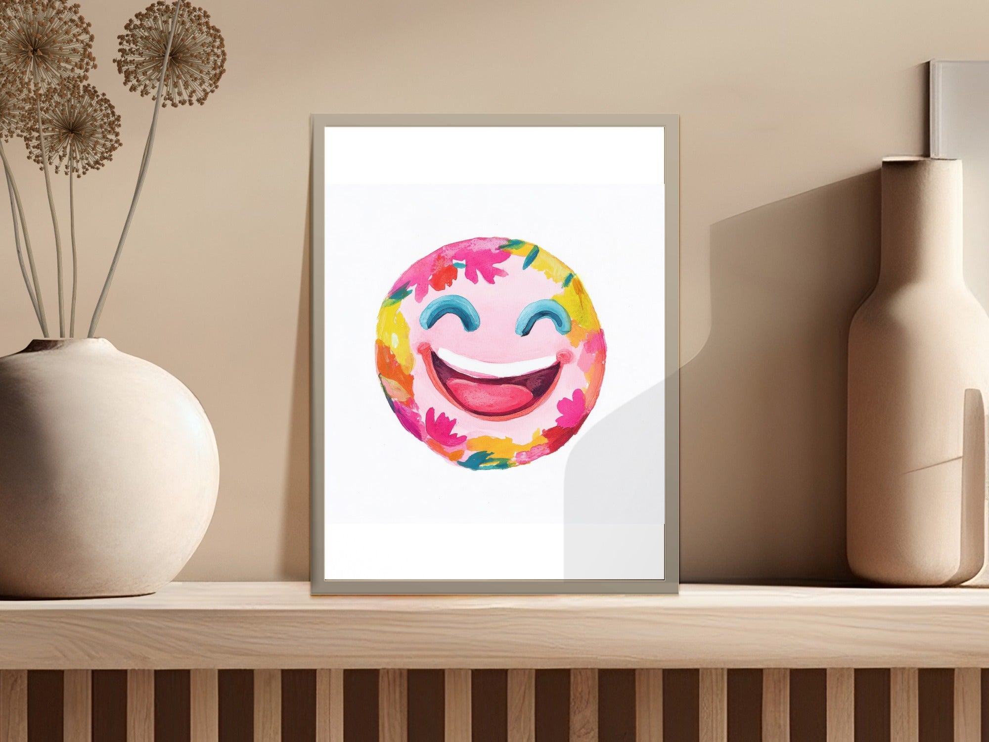 Watercolor smiley face with colorful flower petals and leaves.