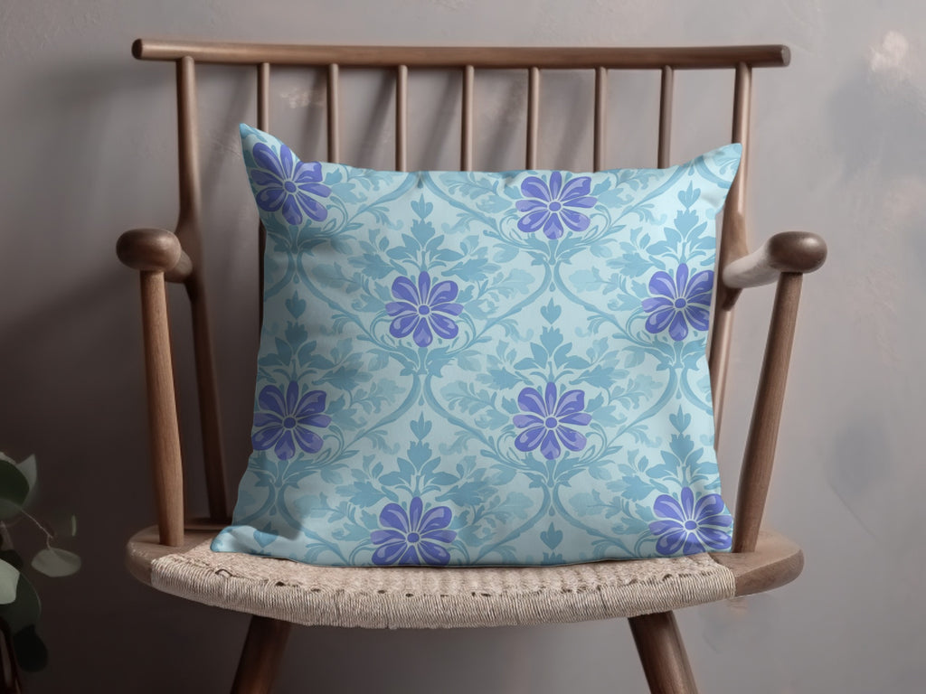 Light blue pillow with a repeating floral pattern on a wooden chair.