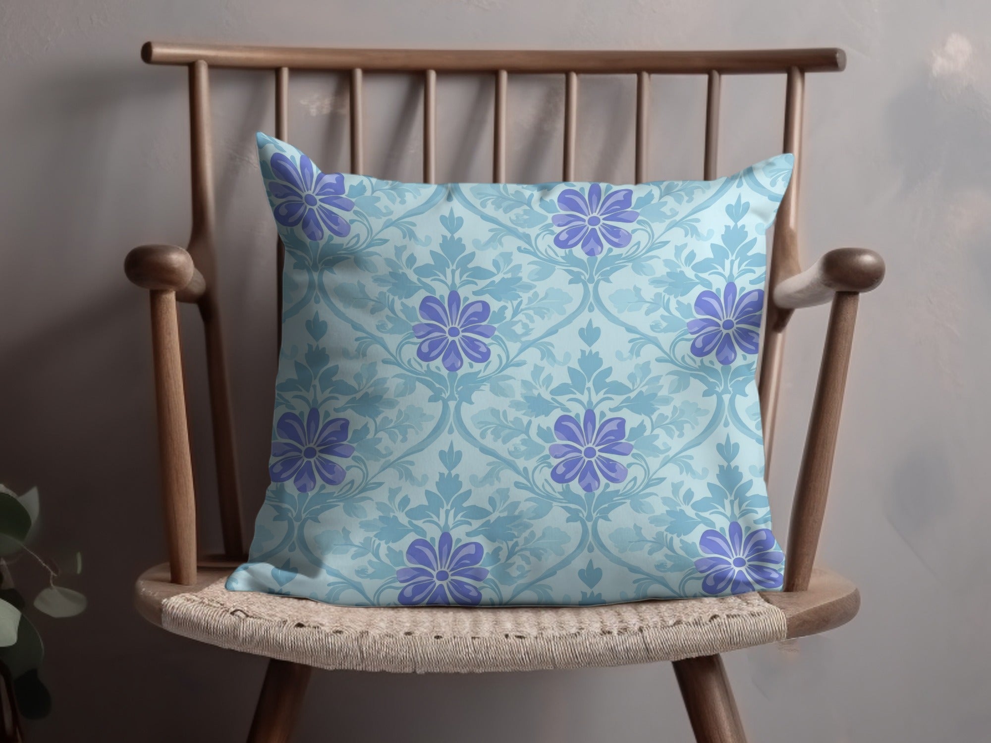 Light blue pillow with a repeating floral pattern on a wooden chair.