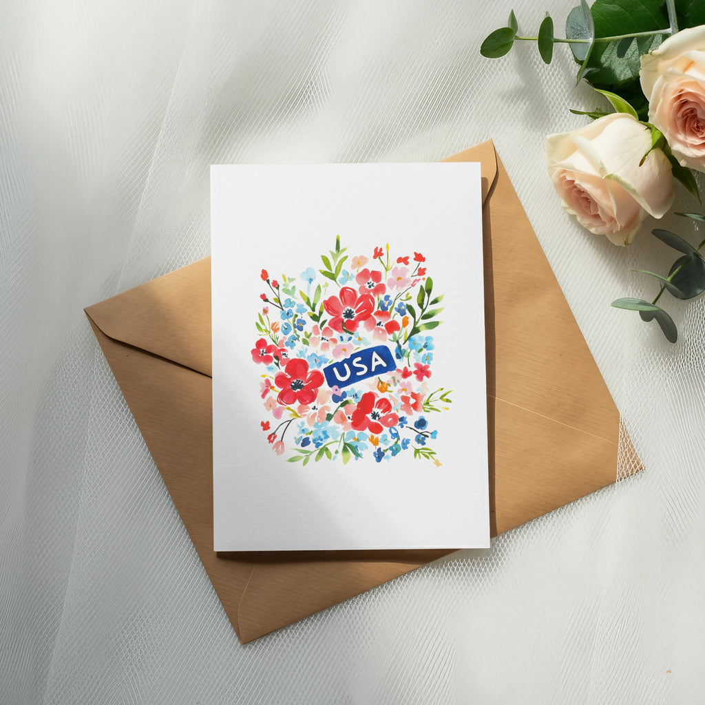 Floral card with "USA" banner resting on an open envelope.