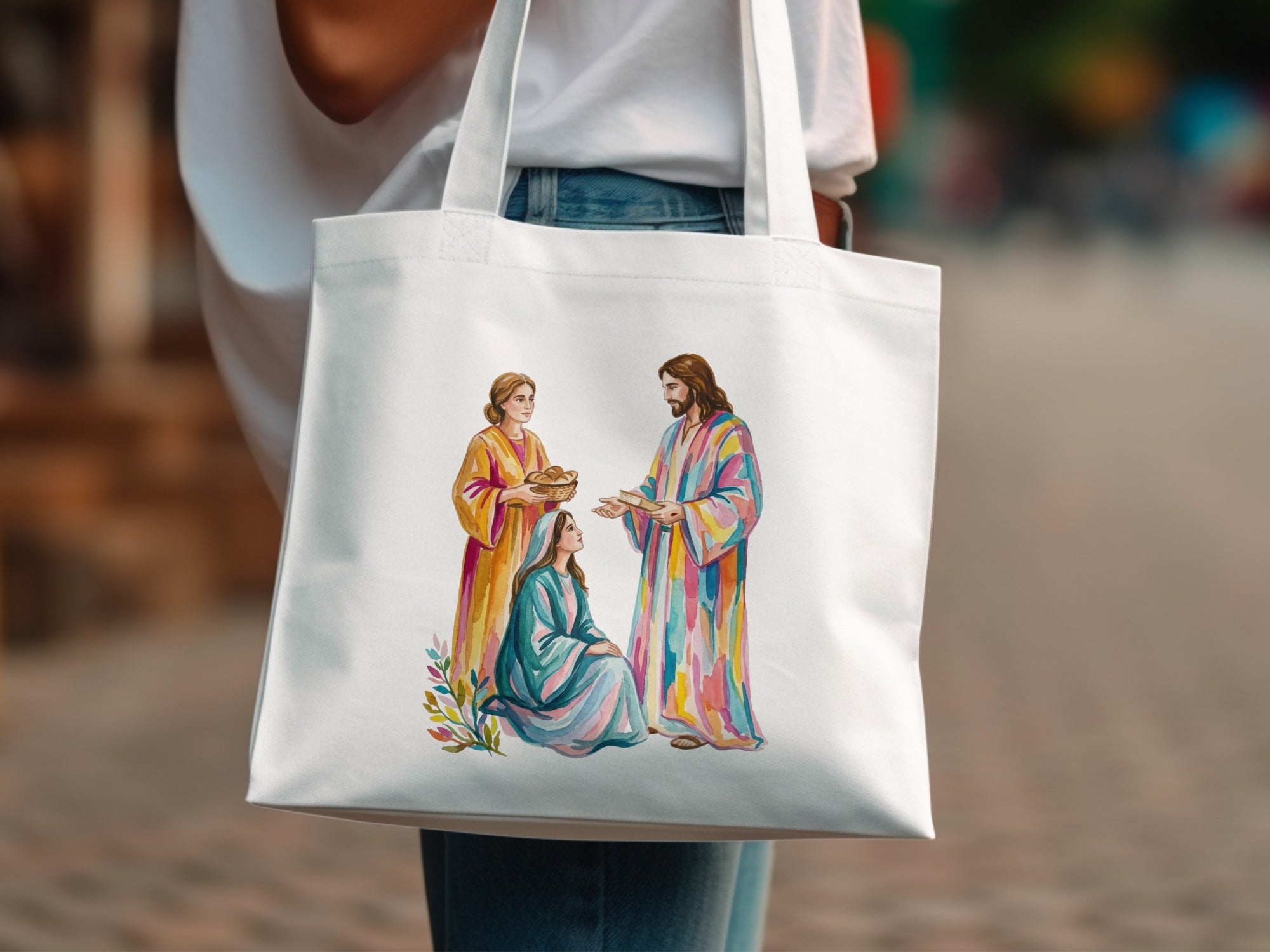 Jesus and two women in colorful robes on a white tote bag.