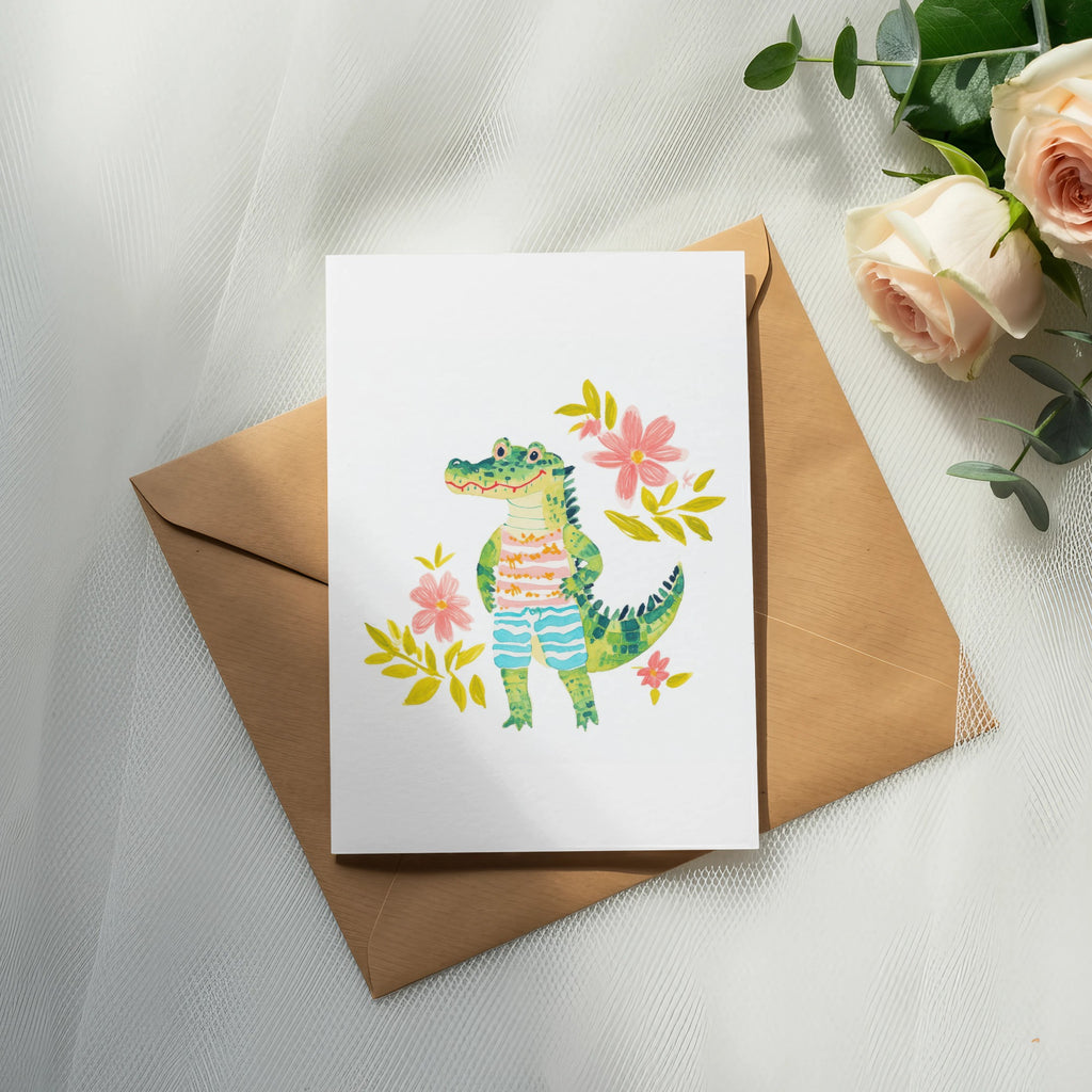 Card with cartoon alligator wearing striped shorts, surrounded by flowers.