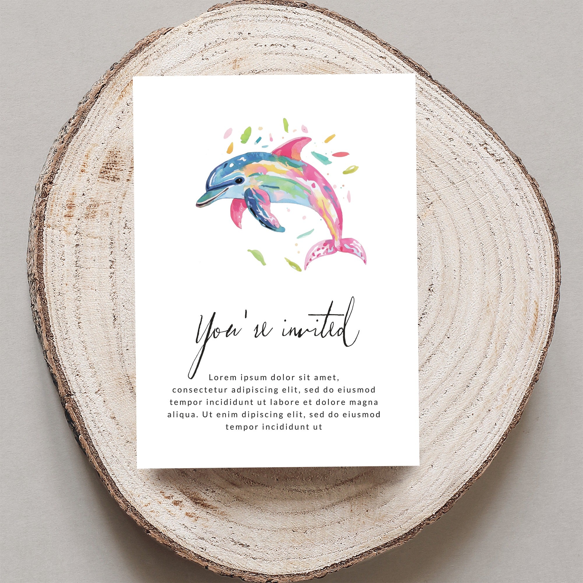 Watercolor dolphin on invitation with "You're invited" text.