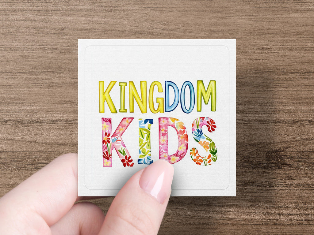 White square with "KINGDOM KIDS" text, letters filled with colorful flowers.