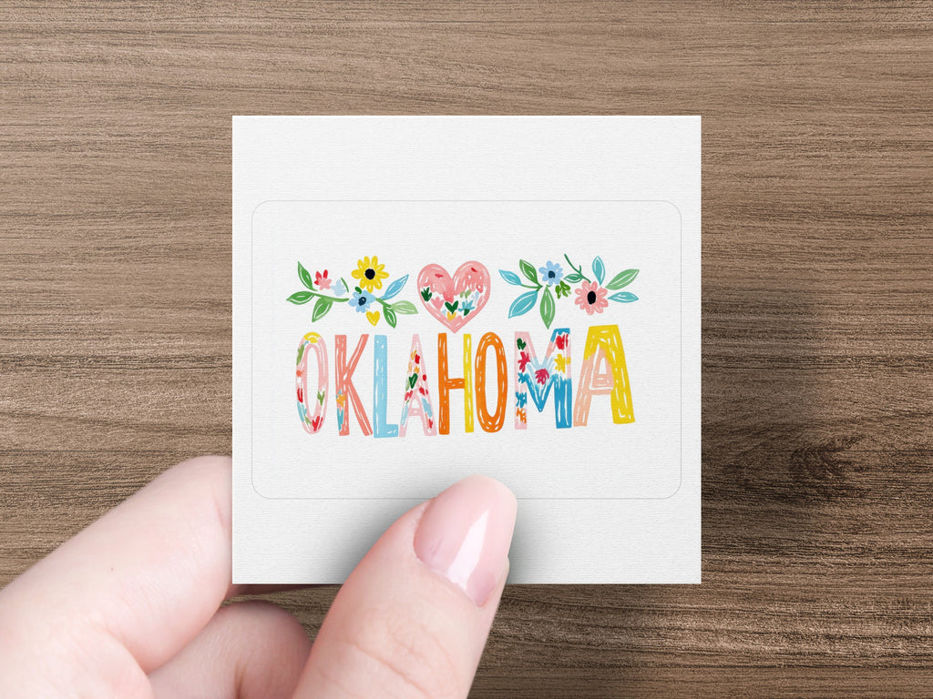 "Oklahoma" spelled with colorful floral letters on a white sticker.