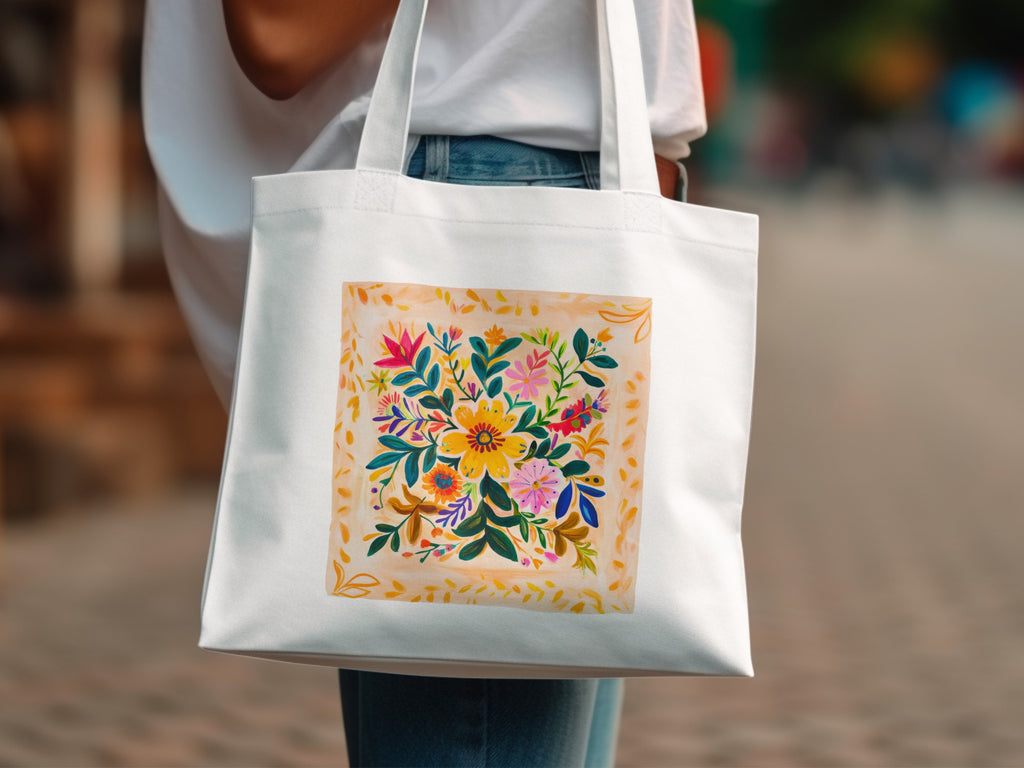 White canvas tote bag with a vibrant floral folk art design.