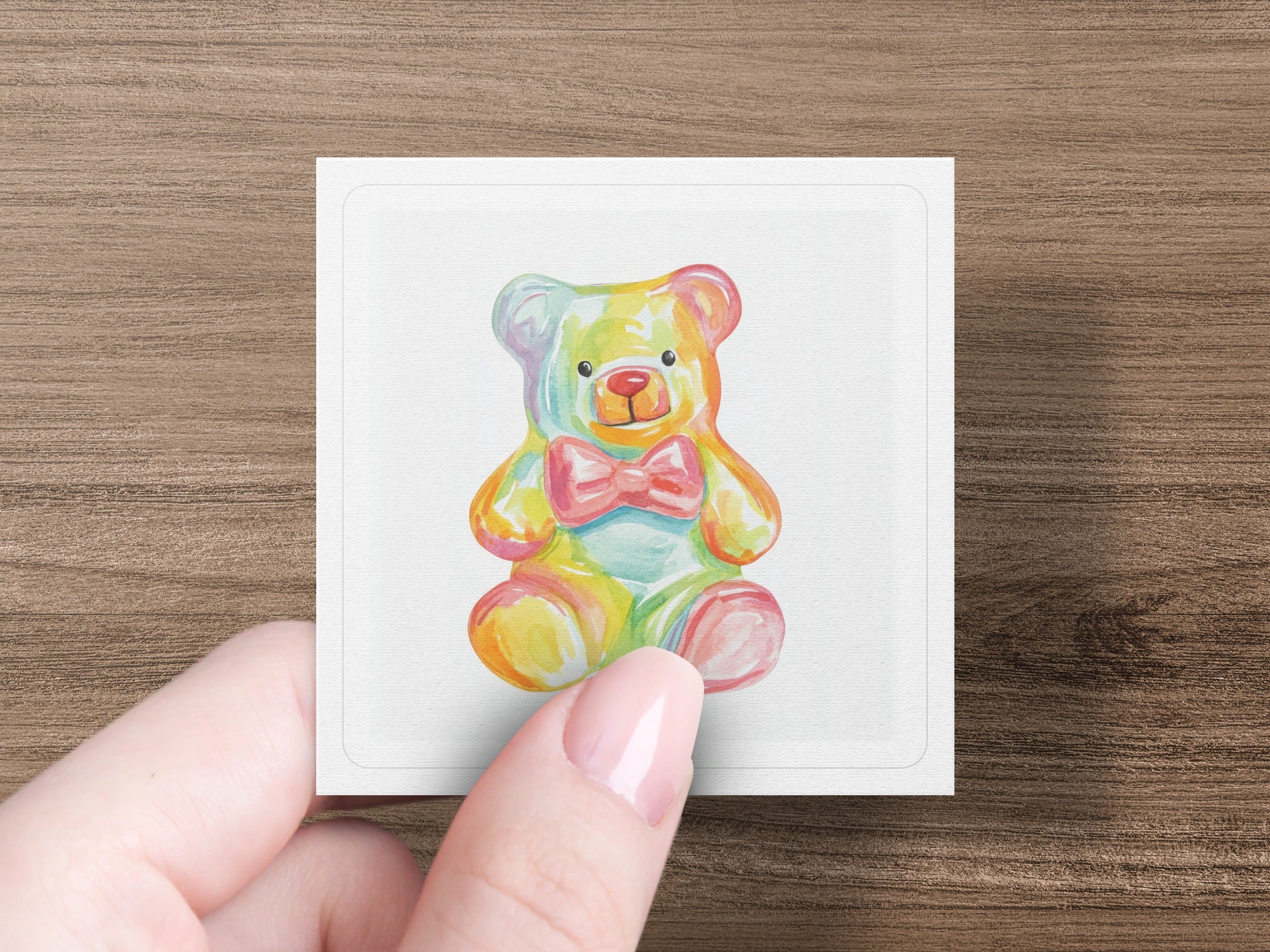 Watercolor teddy bear with colorful gradient, wearing a pink bow tie.