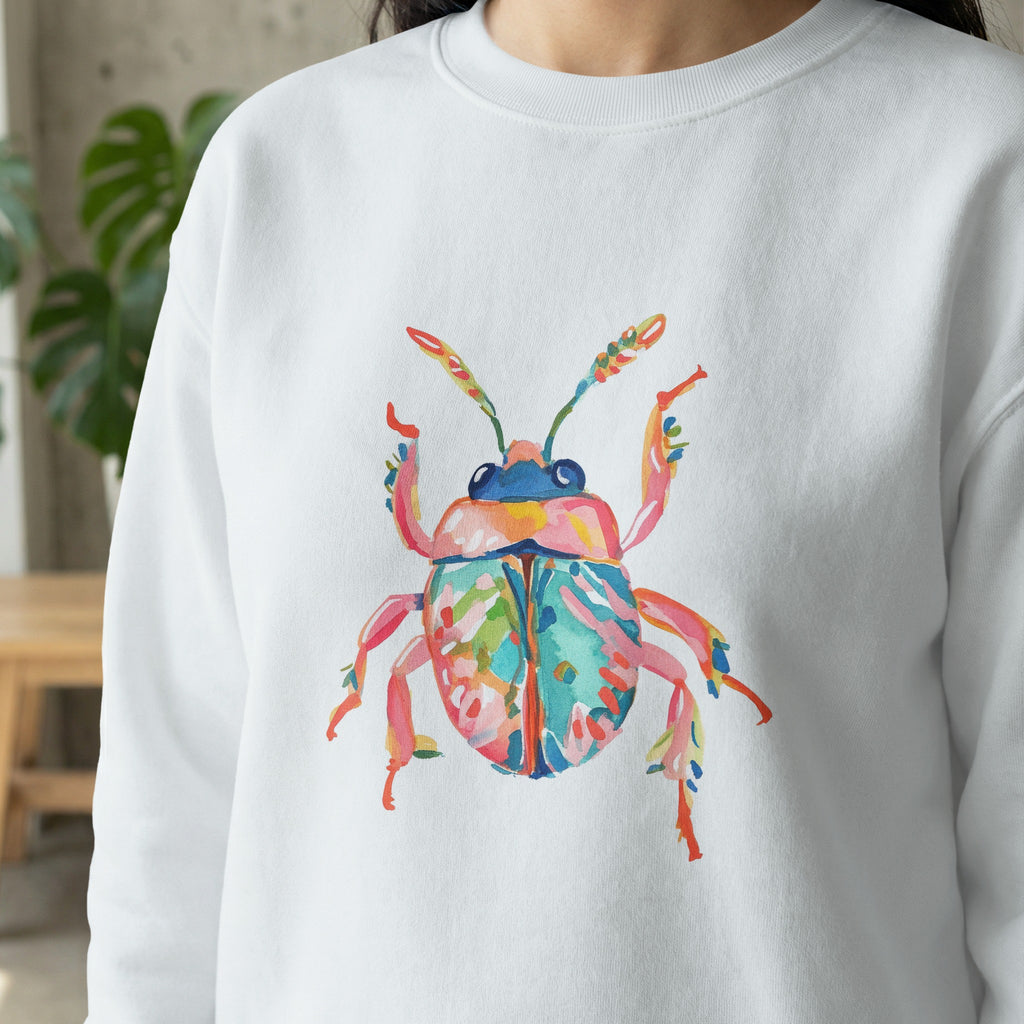 White sweatshirt with a colorful watercolor beetle illustration.