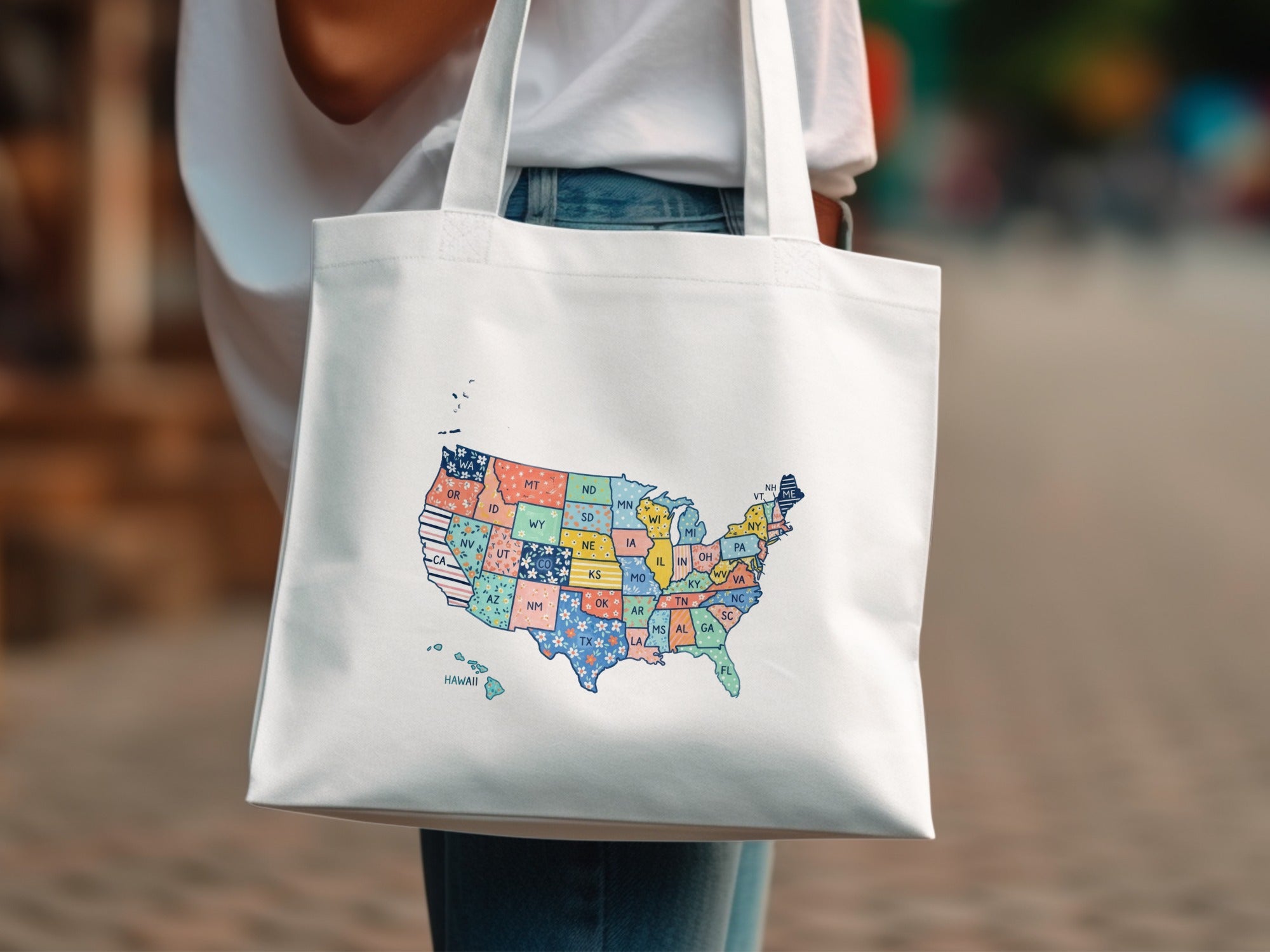 White tote bag with a colorful map of the United States.
