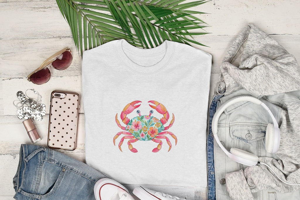 White t-shirt with a colorful floral crab graphic, surrounded by clothing and accessories.