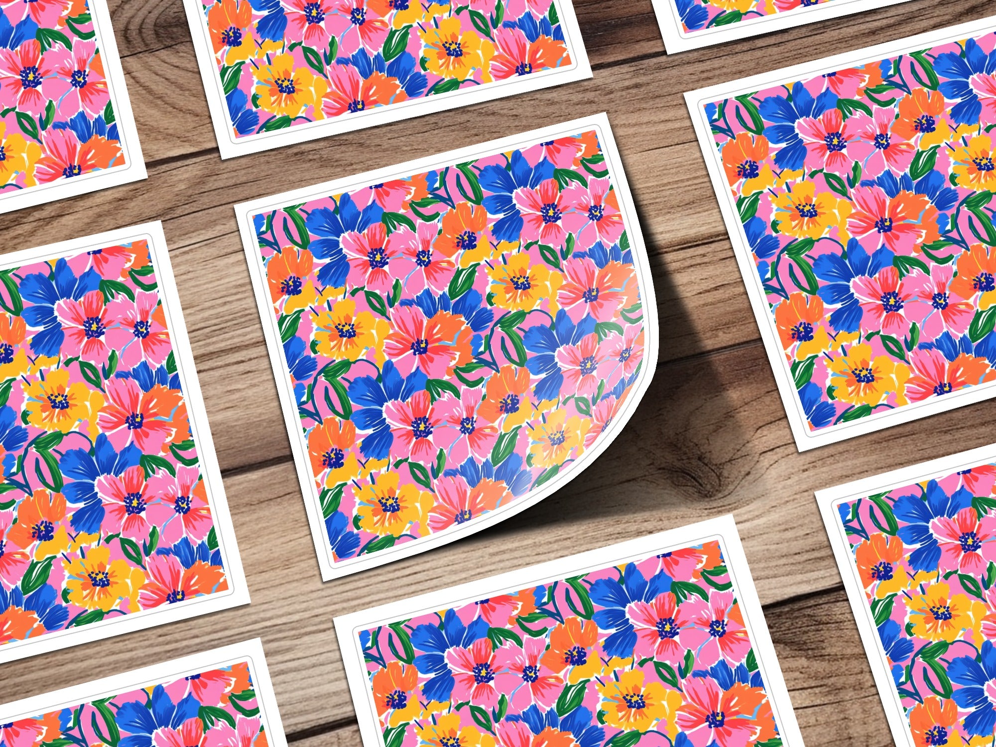 Floral pattern stickers with pink, blue, and yellow flowers on wood background.