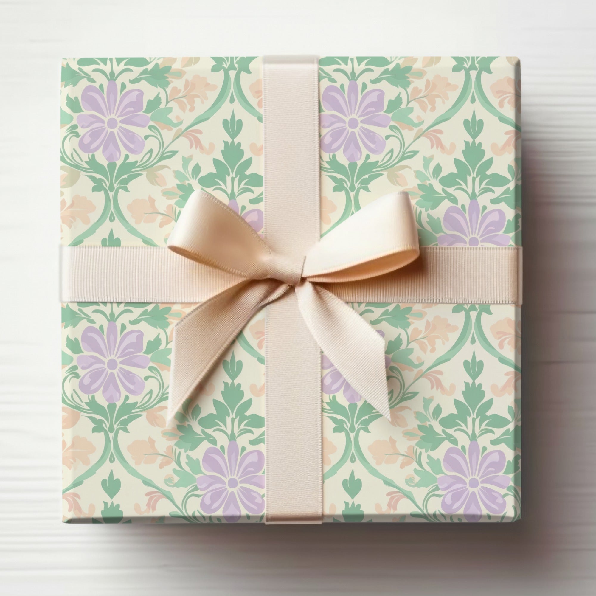 Gift box with floral pattern and beige ribbon bow.