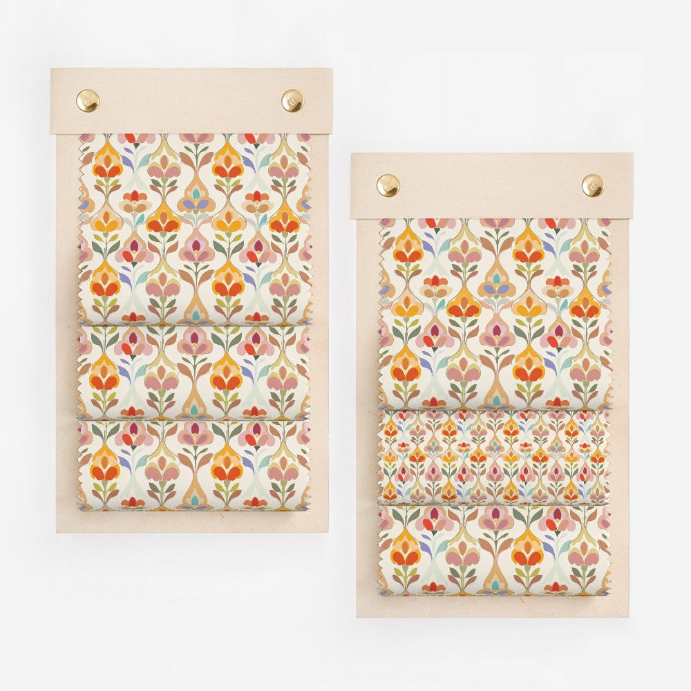 Two swatches of fabric with a repeating floral pattern in red, orange, and blue.