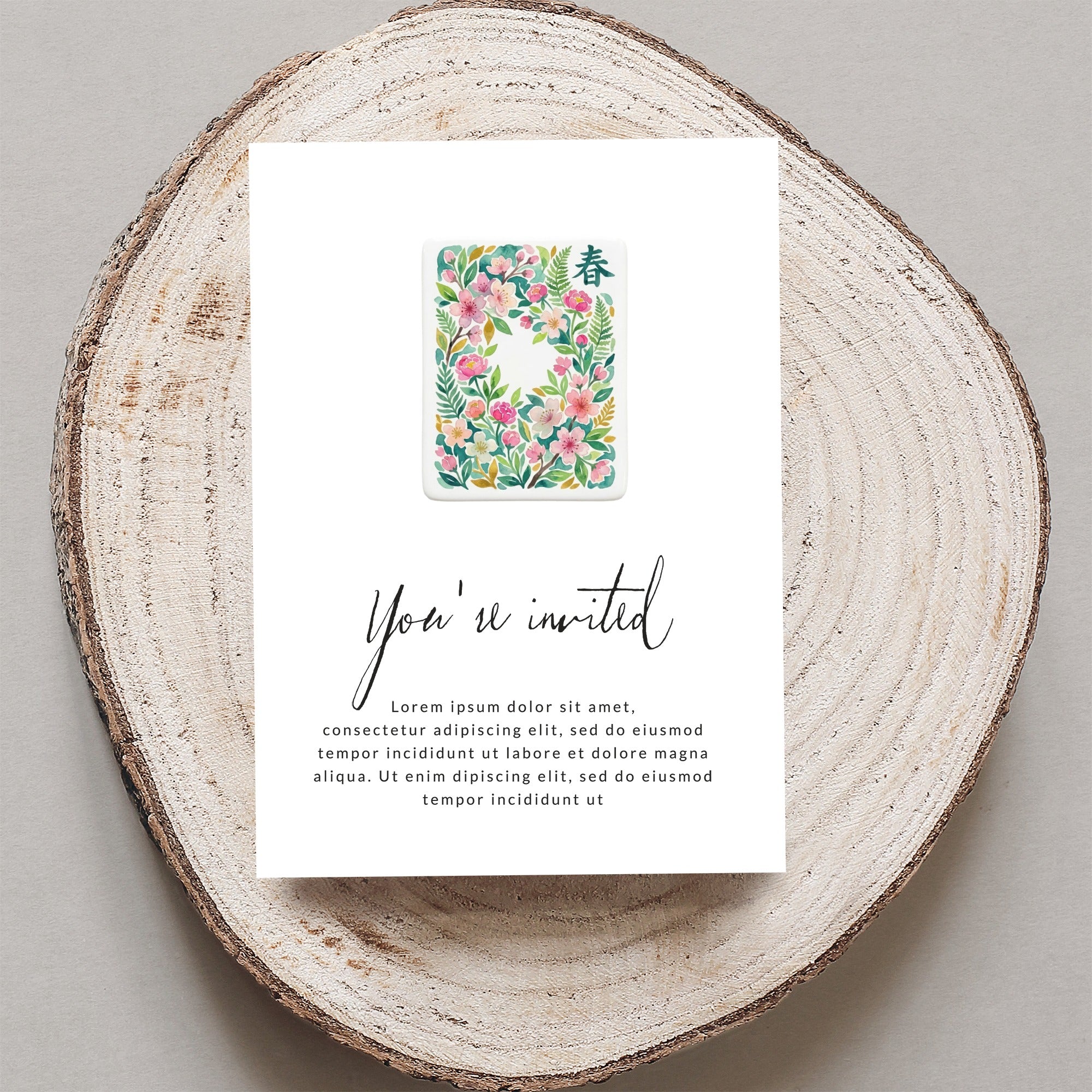 Invitation card with floral motif and "You're invited" text.