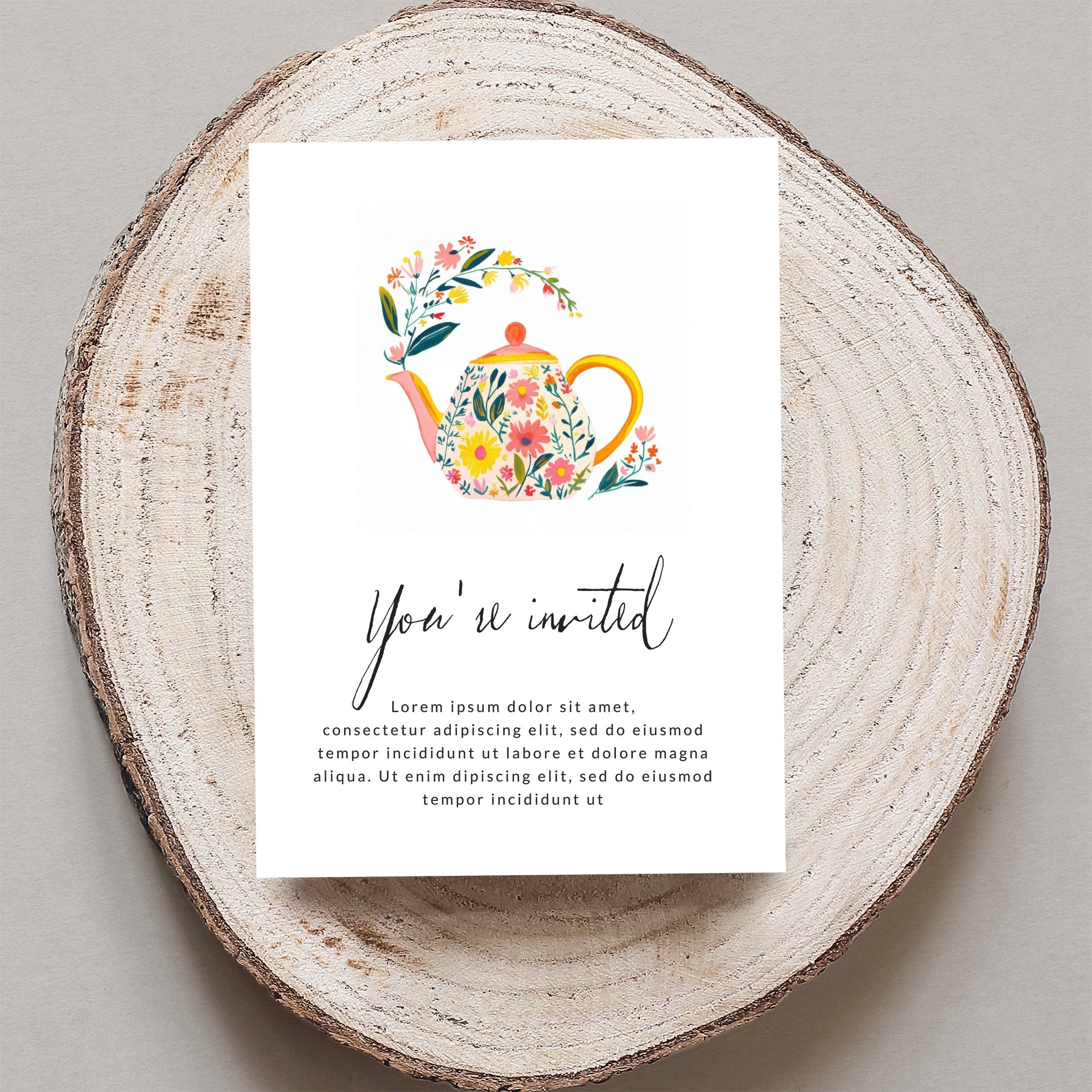 Invitation with floral teapot and "You're invited" text.