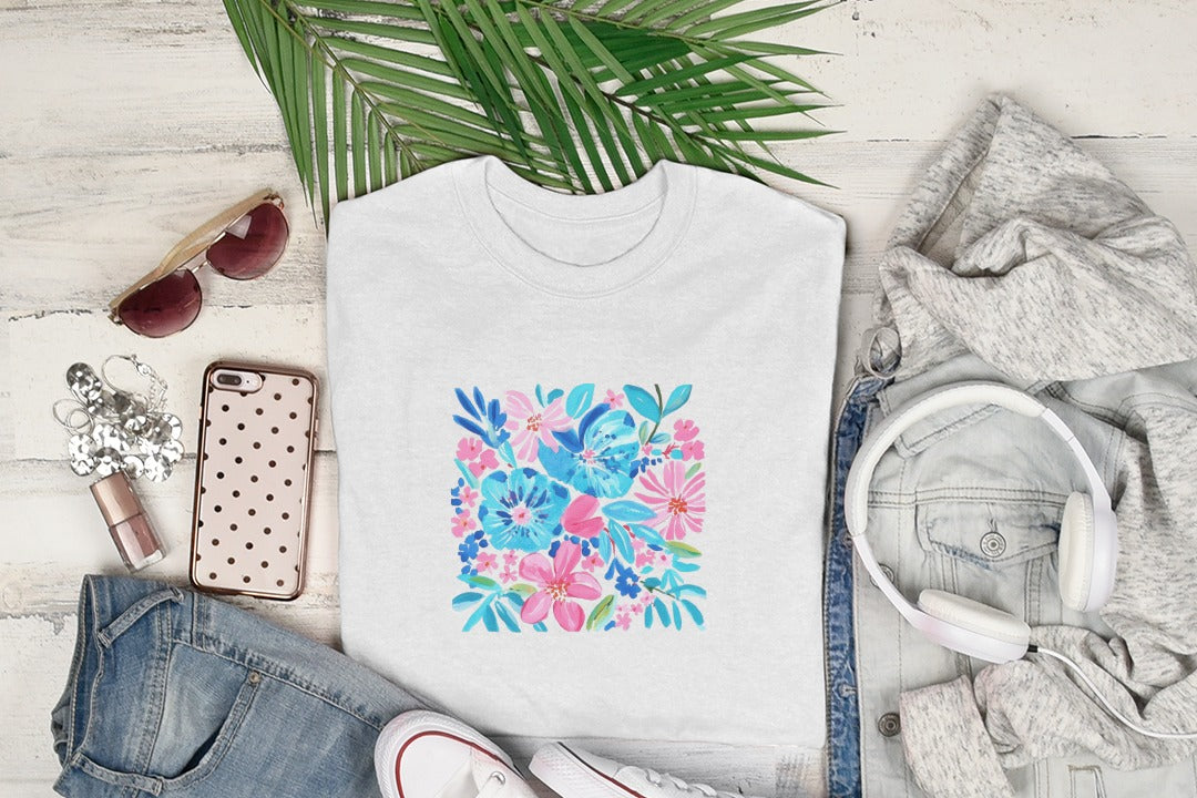 White t-shirt with a floral pattern featuring pink and blue flowers.