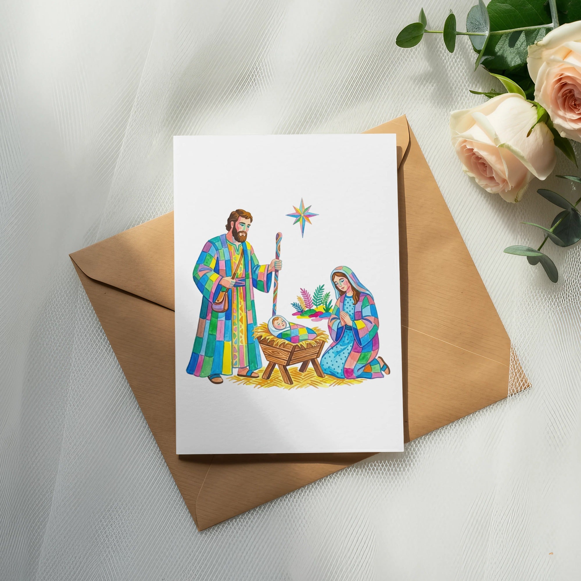 Nativity scene card with Mary, Joseph, baby Jesus, and star on brown envelope.