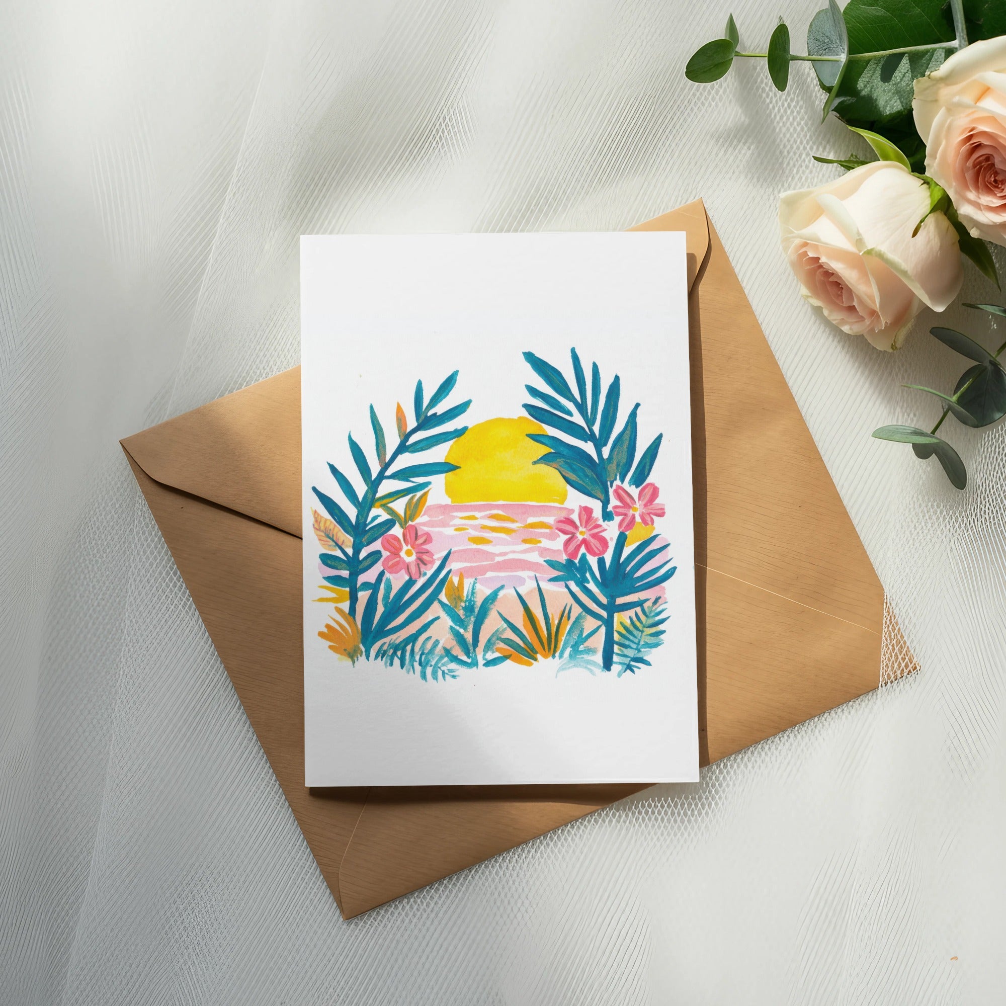 Watercolor card with sunset, palm leaves, and flowers on a kraft envelope.