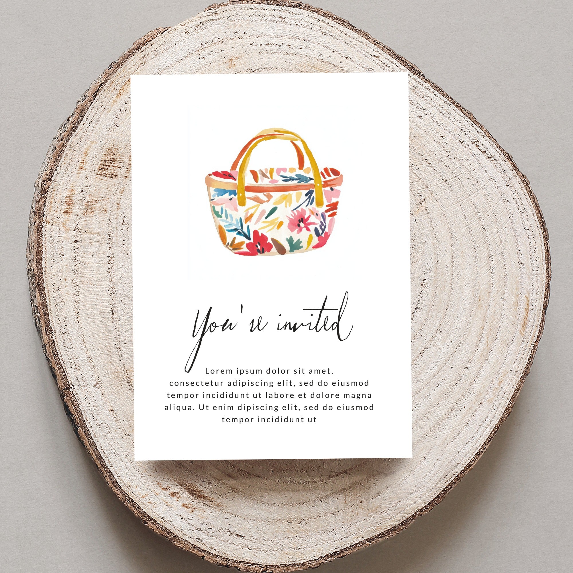 Floral picnic basket invitation with "You're invited" text.