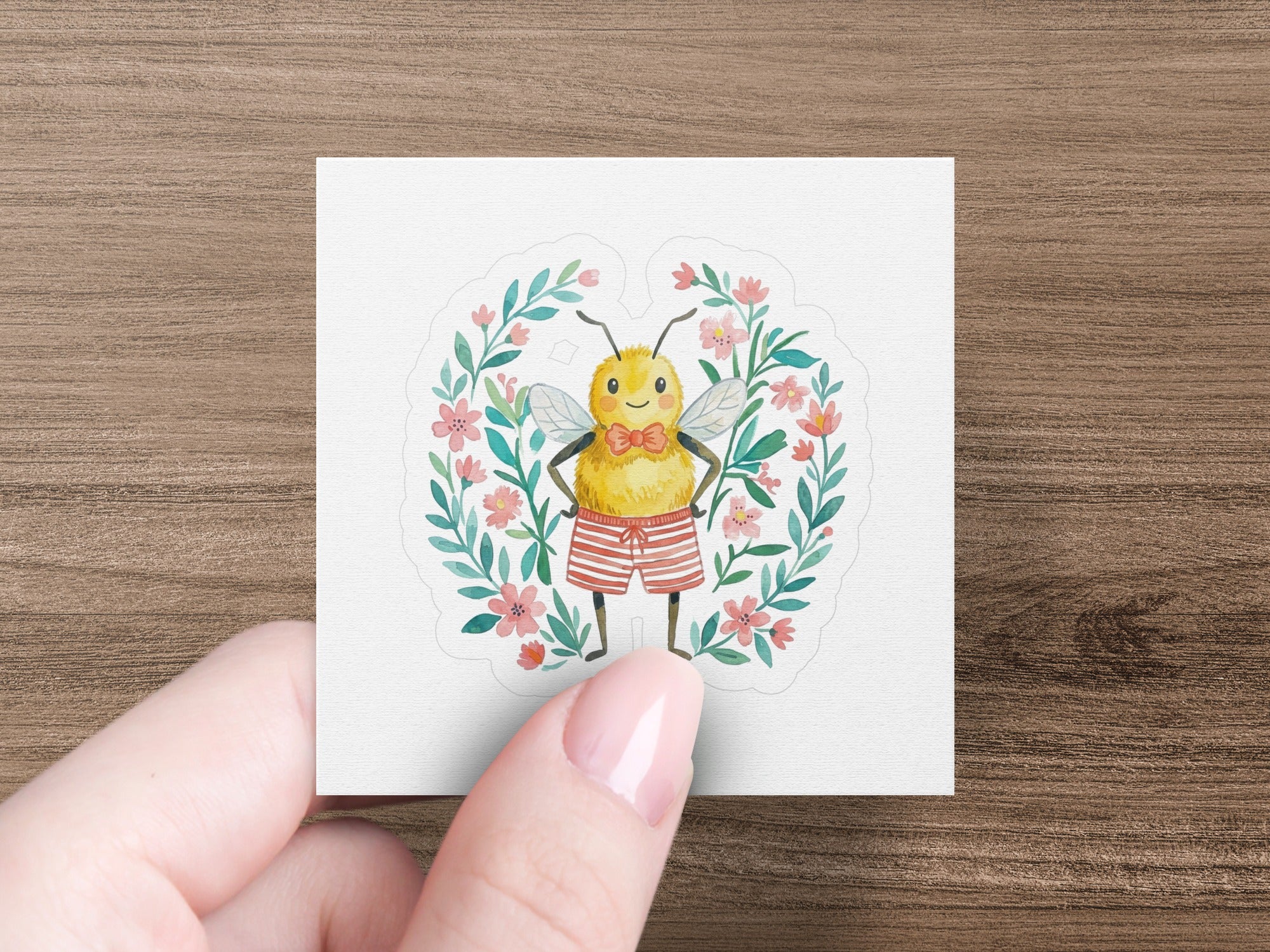 Cute bee wearing striped shorts and a bowtie, framed by flowers.