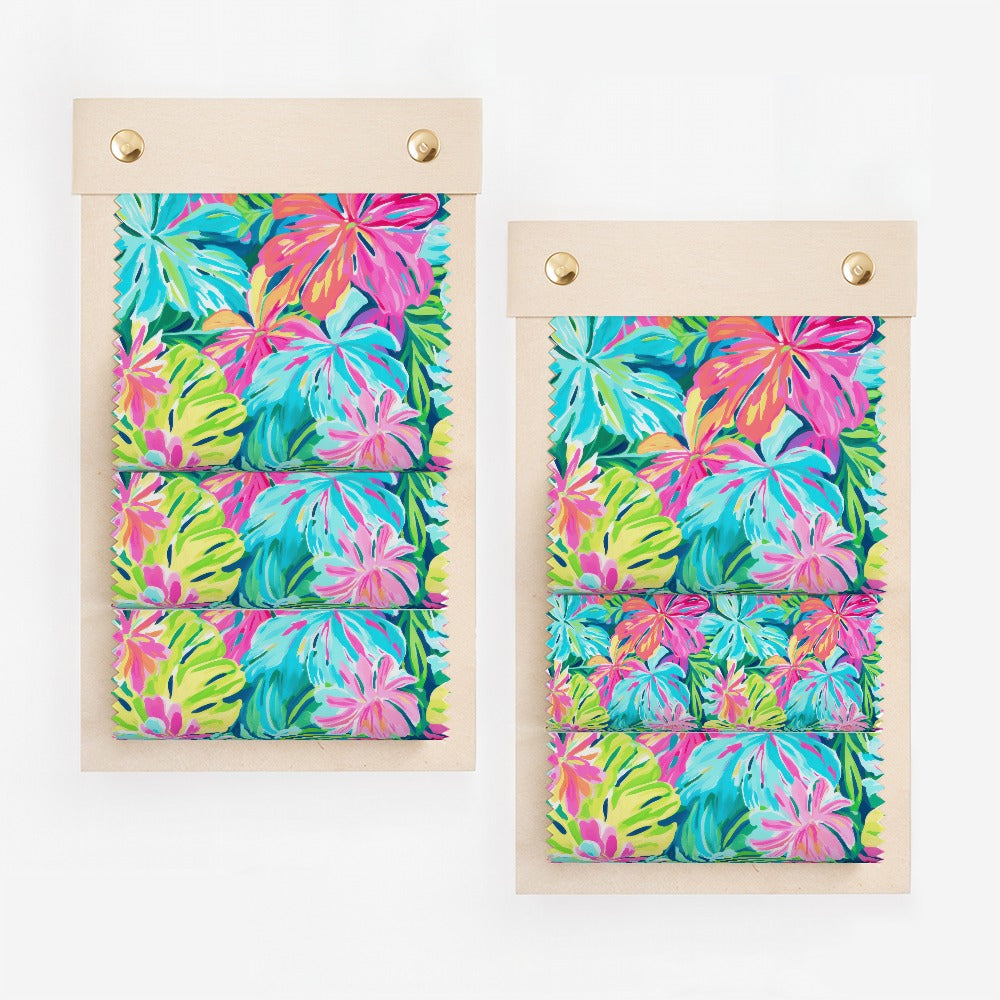 Two fabric swatches with a vibrant tropical leaf print.