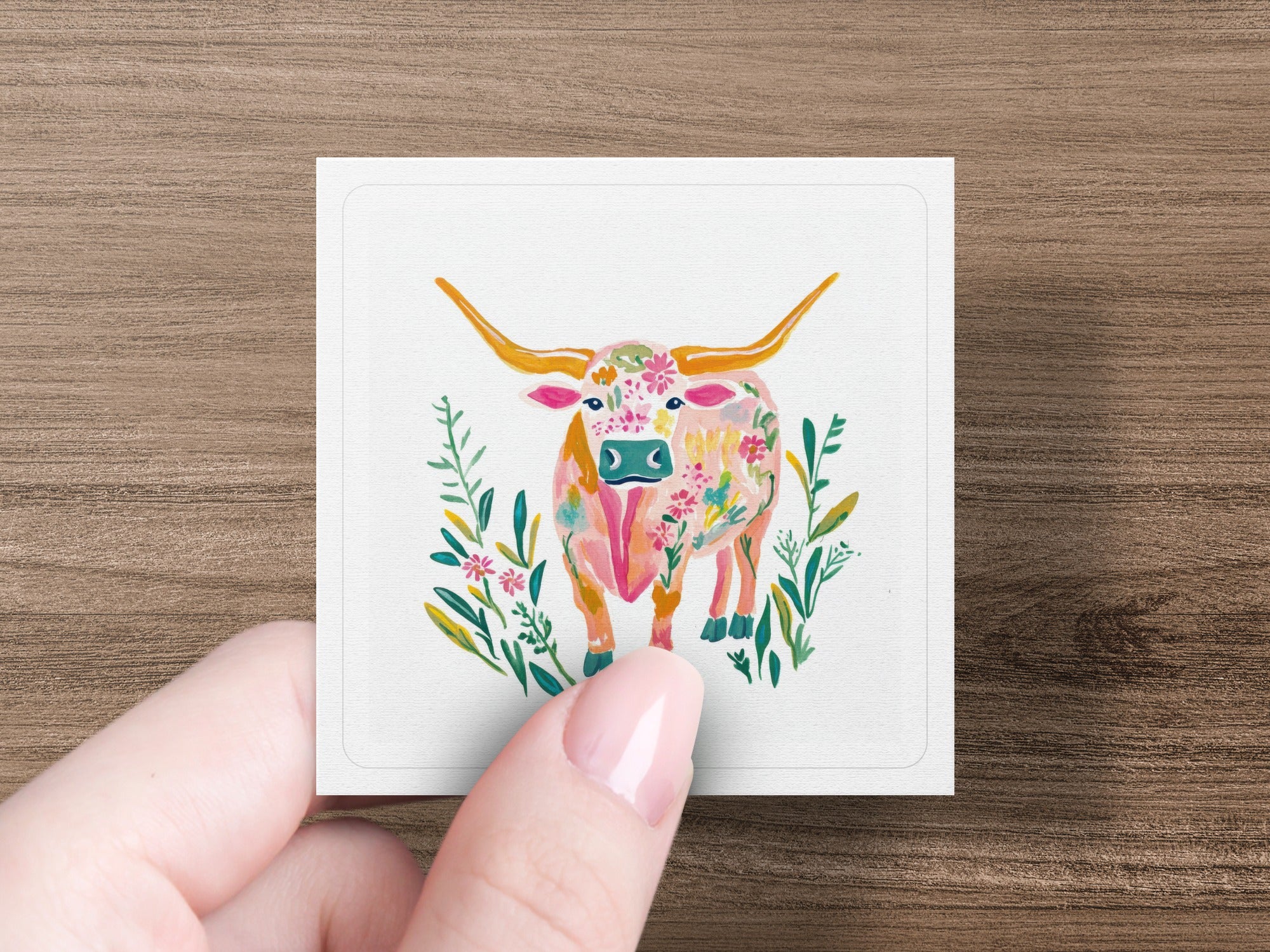 Watercolor painting of a longhorn bull with floral pattern.