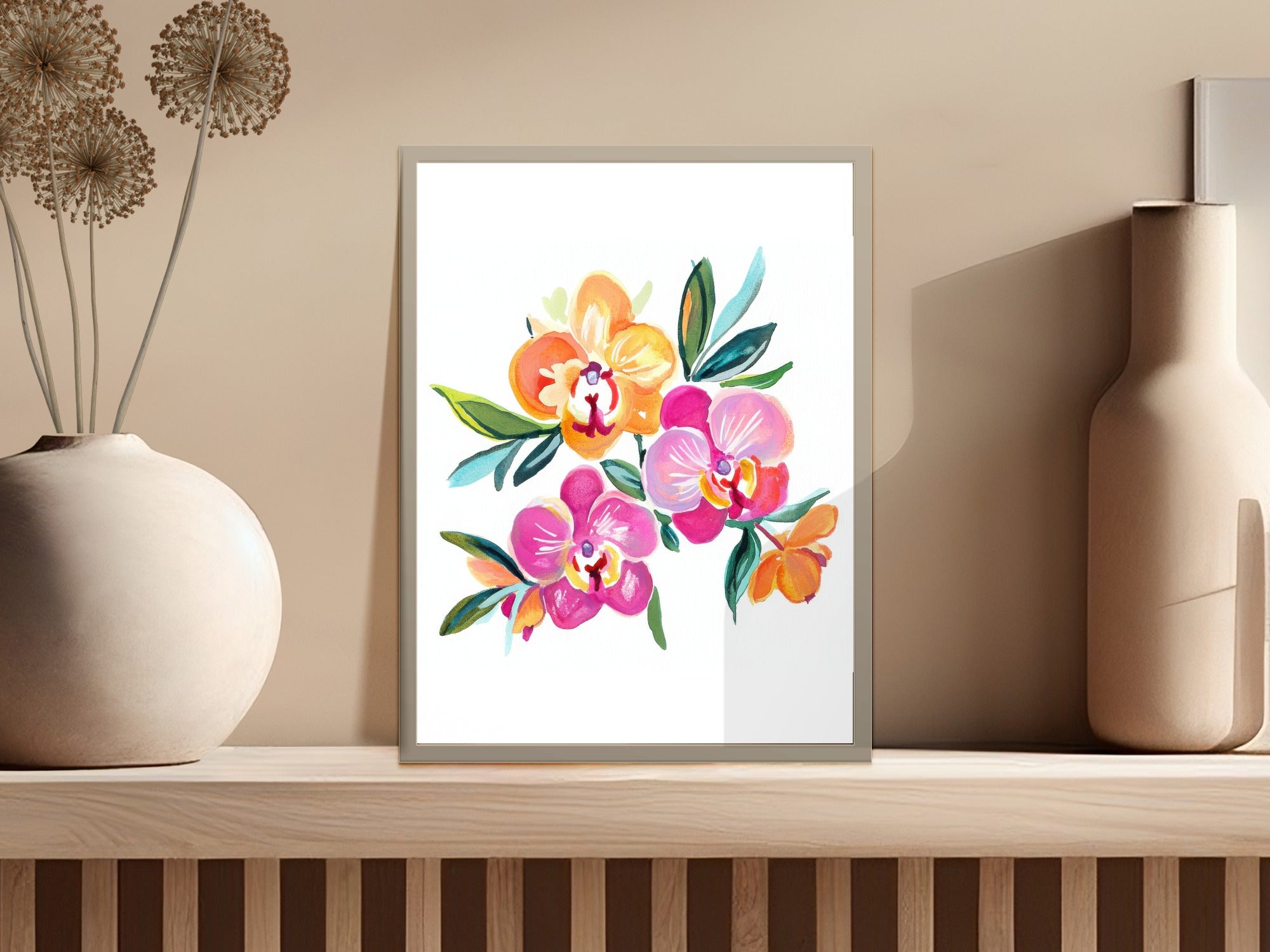 Colorful watercolor orchid bouquet in a frame on a shelf.