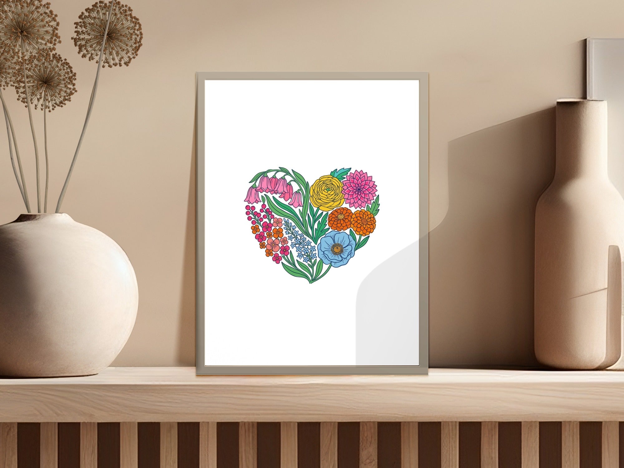 Floral heart artwork with pink, orange, yellow, and blue flowers on a shelf.
