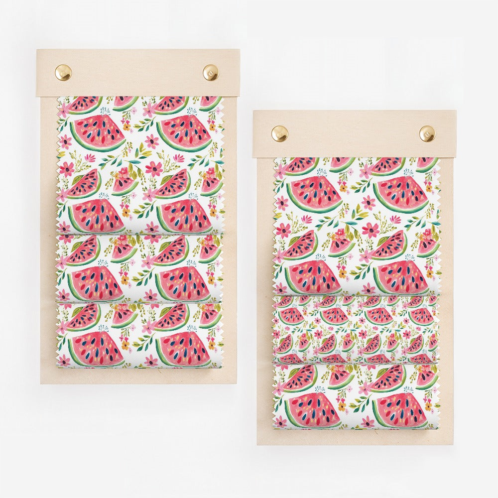Fabric swatch samples featuring a repeating pattern of sliced watermelons and pink flowers.