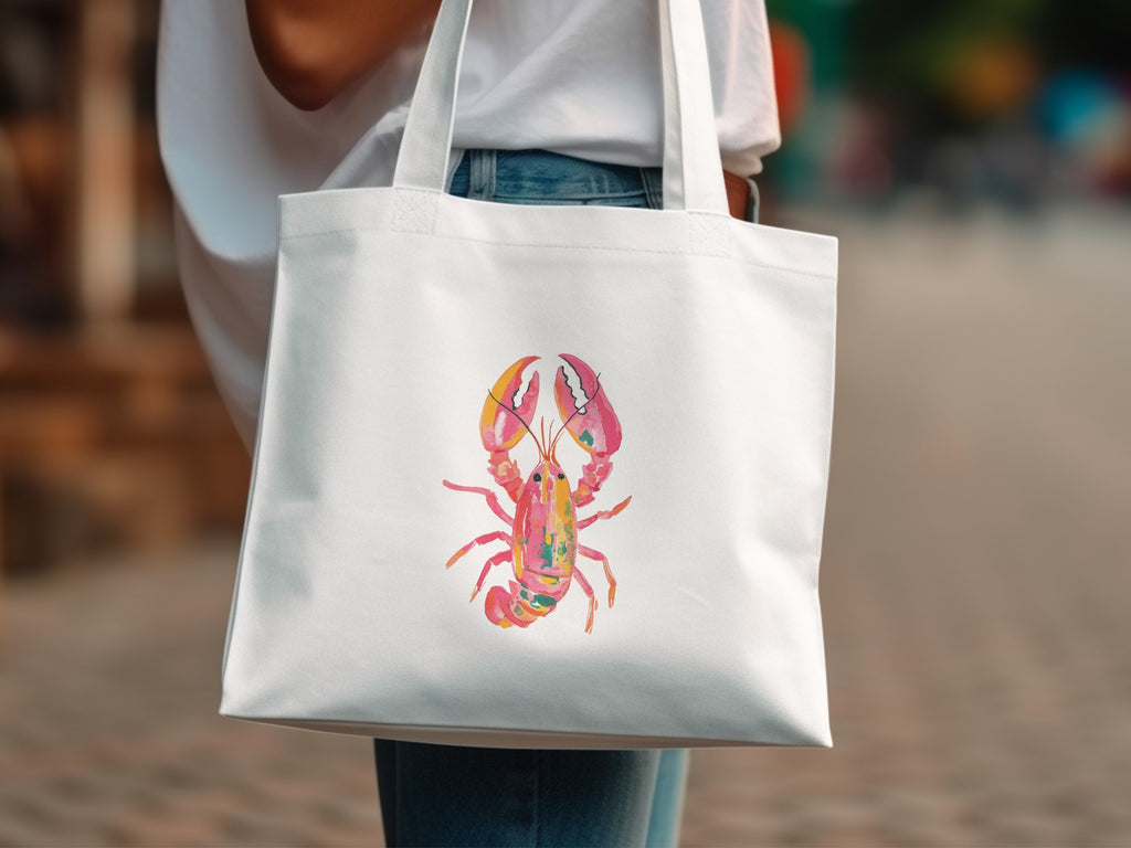 White tote bag with a watercolor illustration of a pink and yellow lobster.