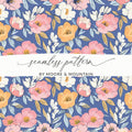 Seamless floral pattern with pink, white, and yellow flowers on blue background.