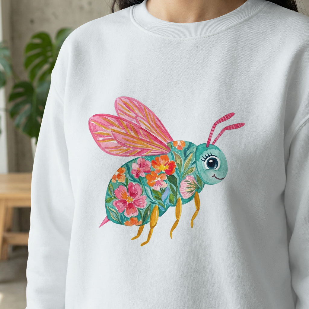 White sweatshirt with a colorful floral bee illustration.