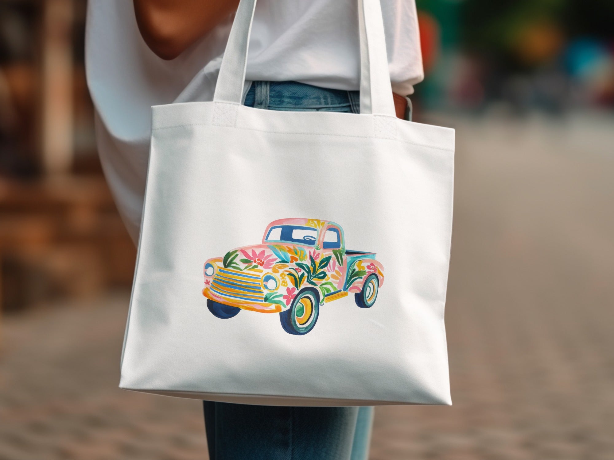 White tote bag with a colorful floral truck design.
