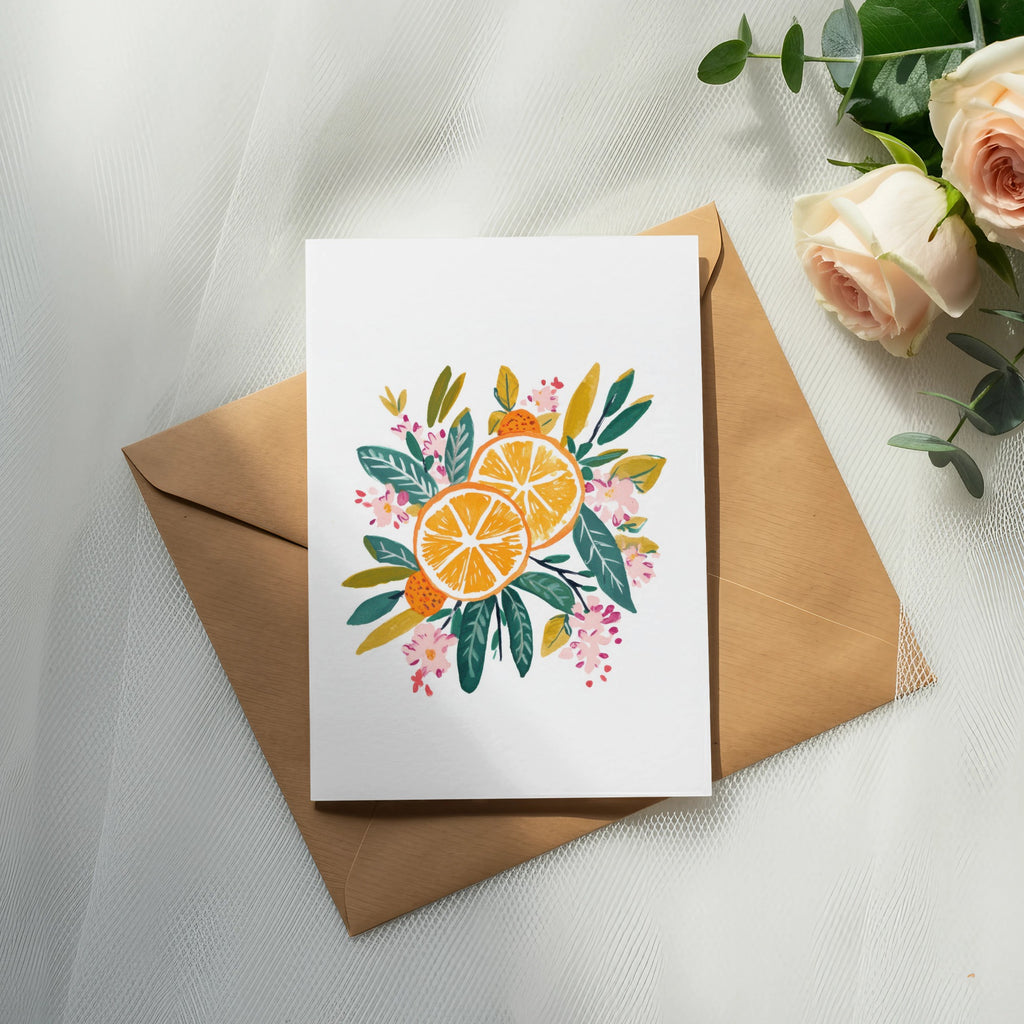 Card with citrus slices and floral illustration on kraft envelope.
