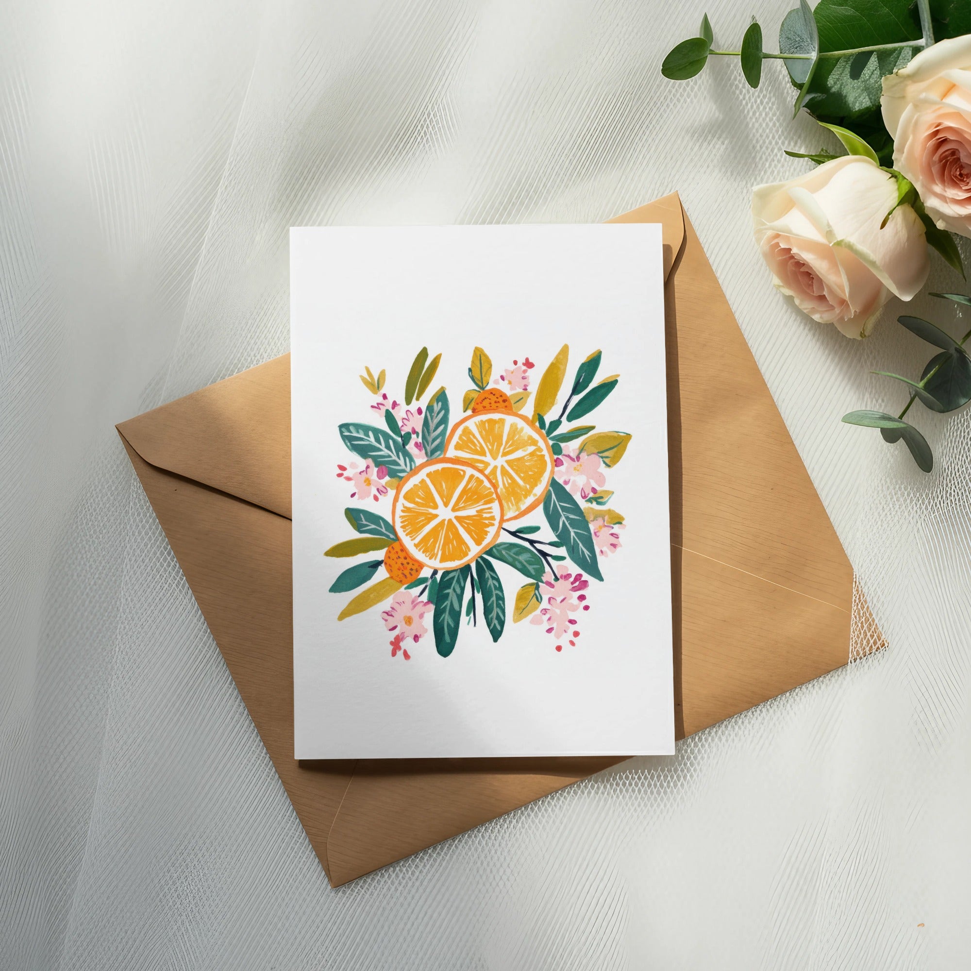 Card with citrus slices and floral illustration on kraft envelope.