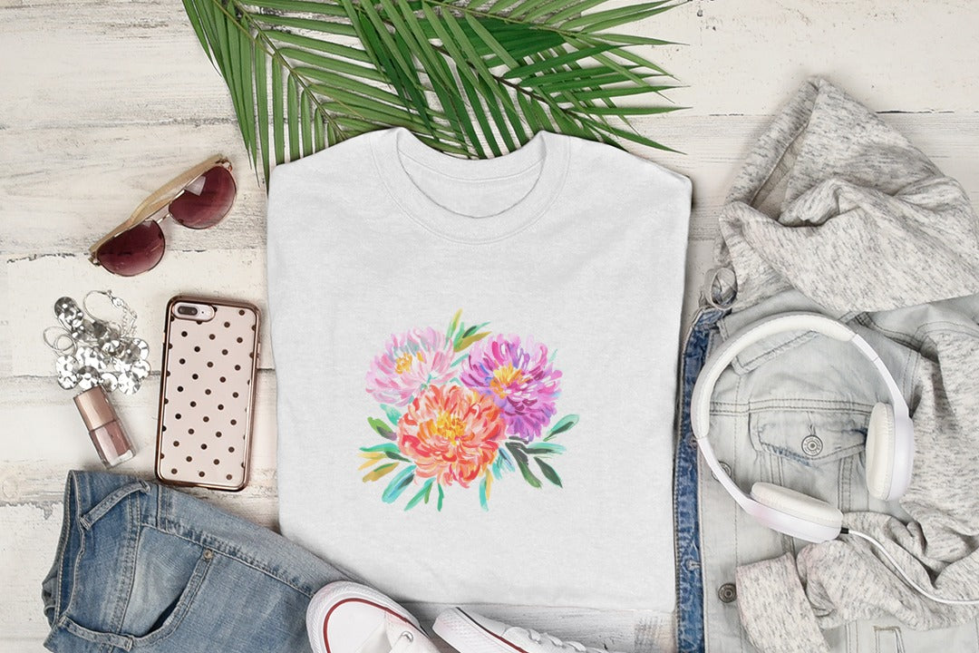 White t-shirt with a colorful floral watercolor design.