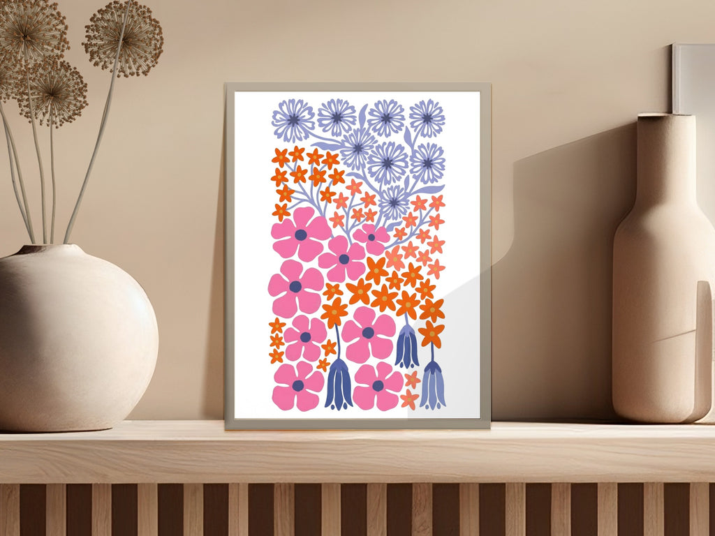 Abstract floral print with pink, orange, and blue flowers on a light background.