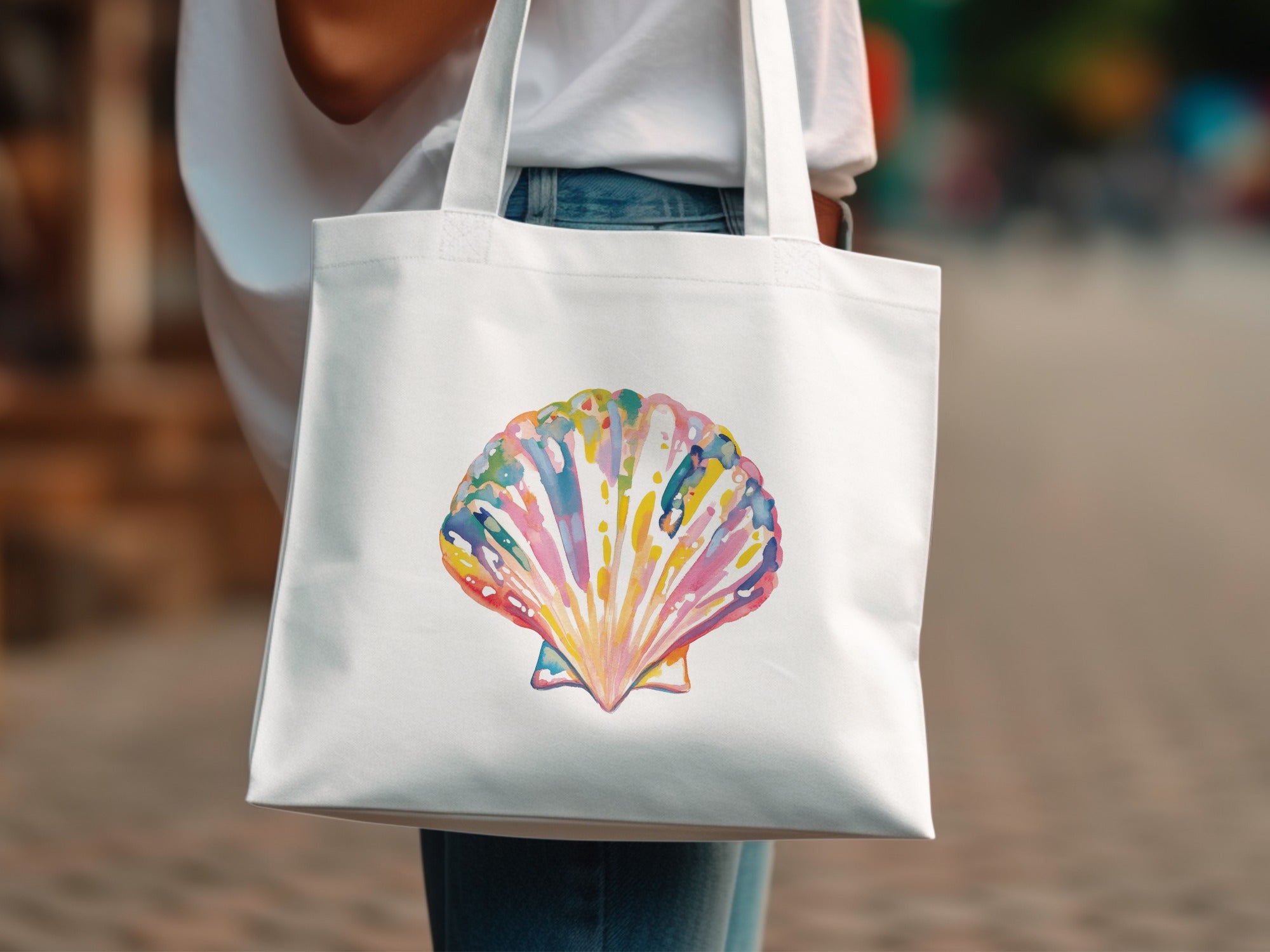 White tote bag with a colorful watercolor scallop shell design.