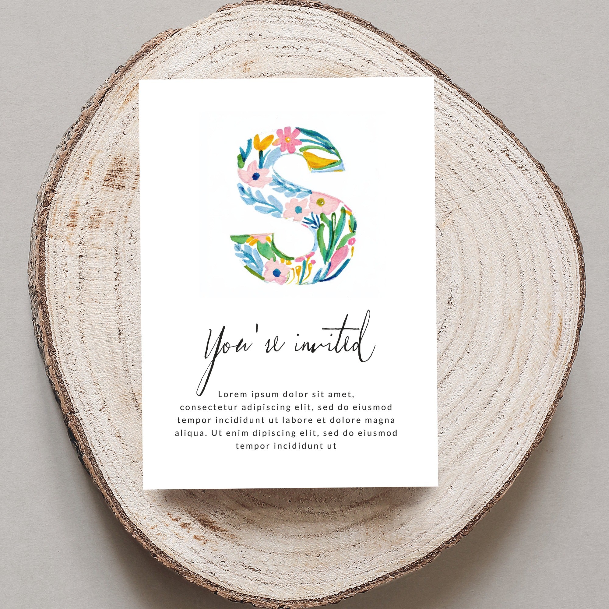 Invitation with floral letter S and placeholder text.