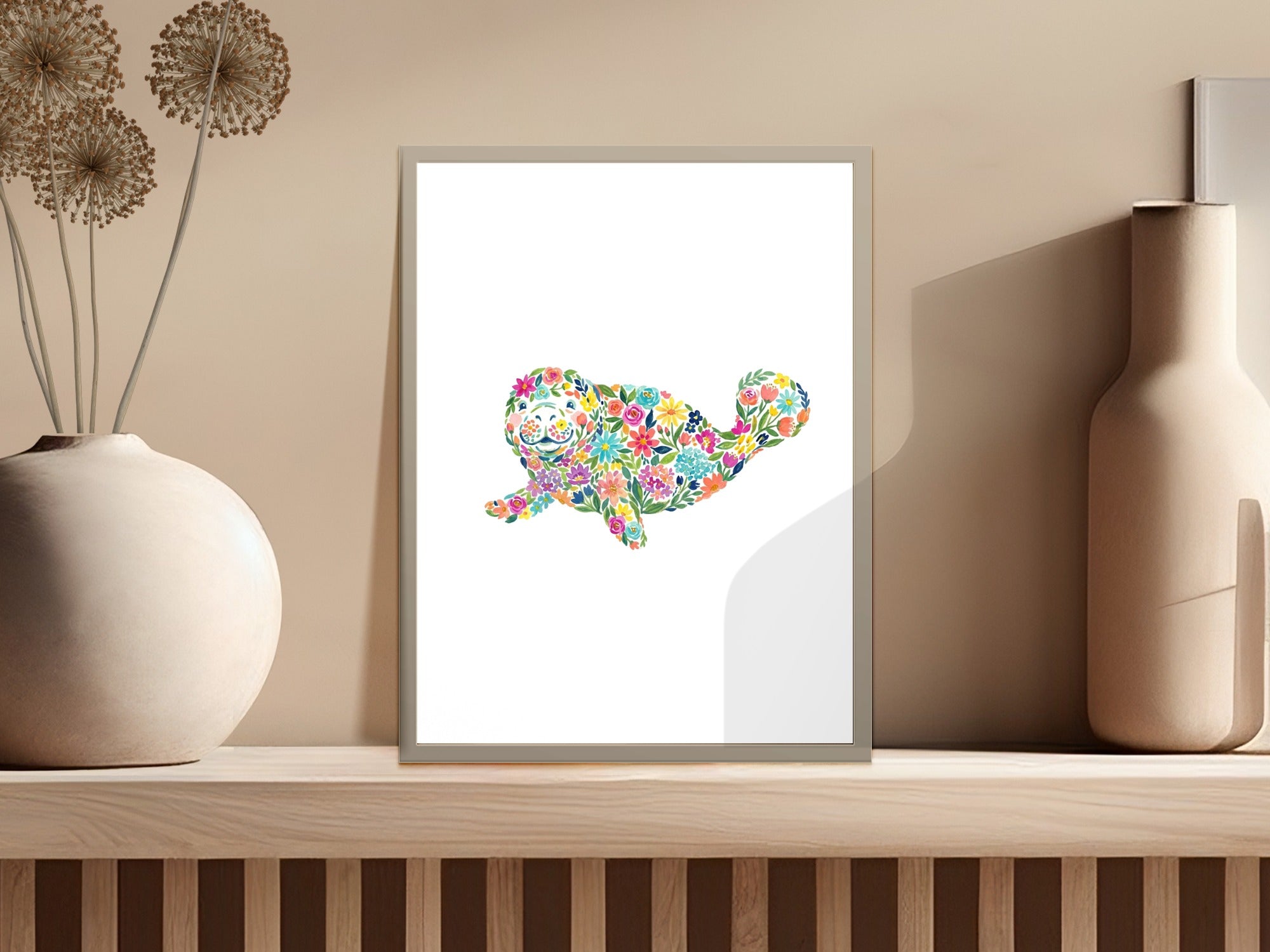 Whimsical whale illustration with colorful floral pattern on a framed print.