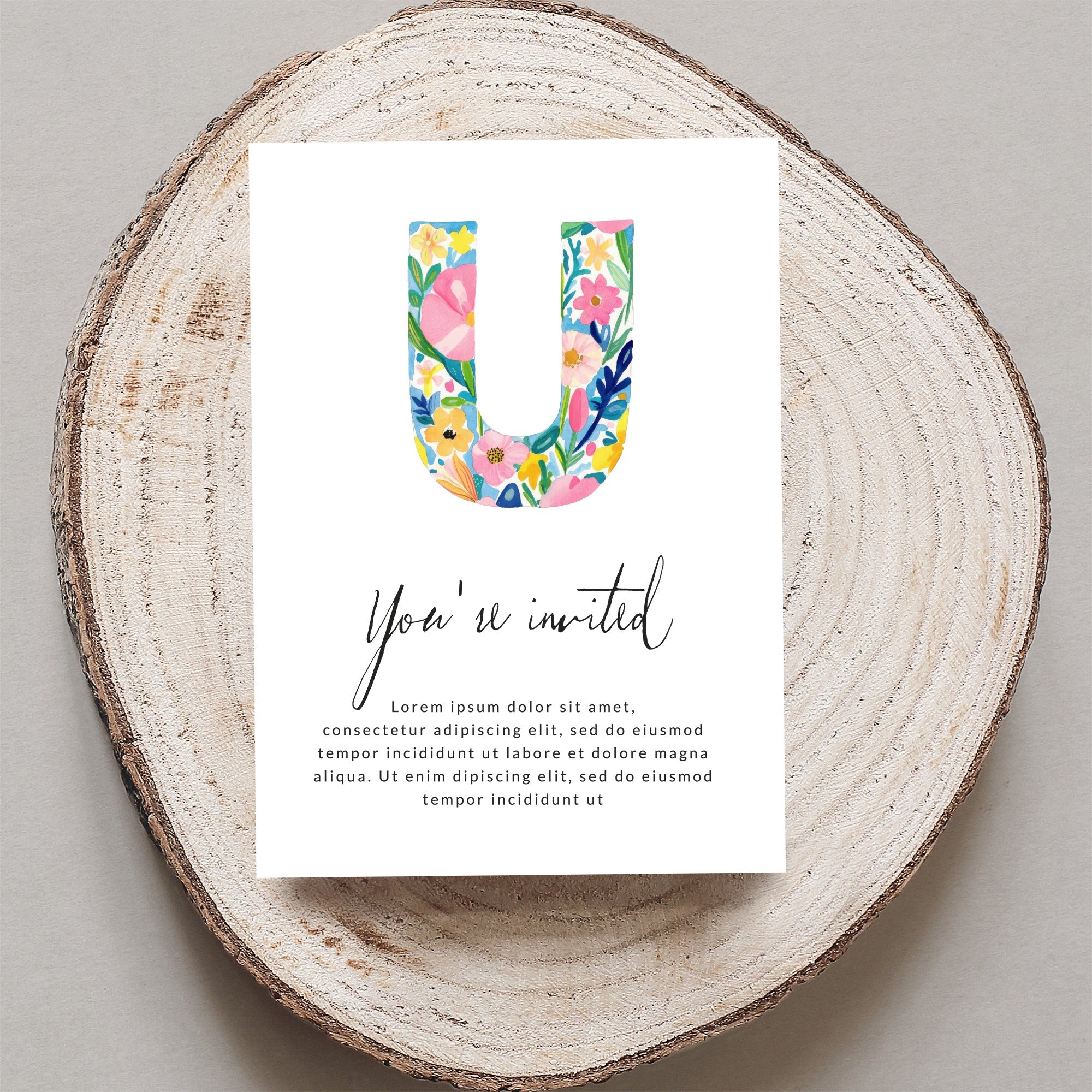 "You're invited" card with large floral letter U and placeholder text.