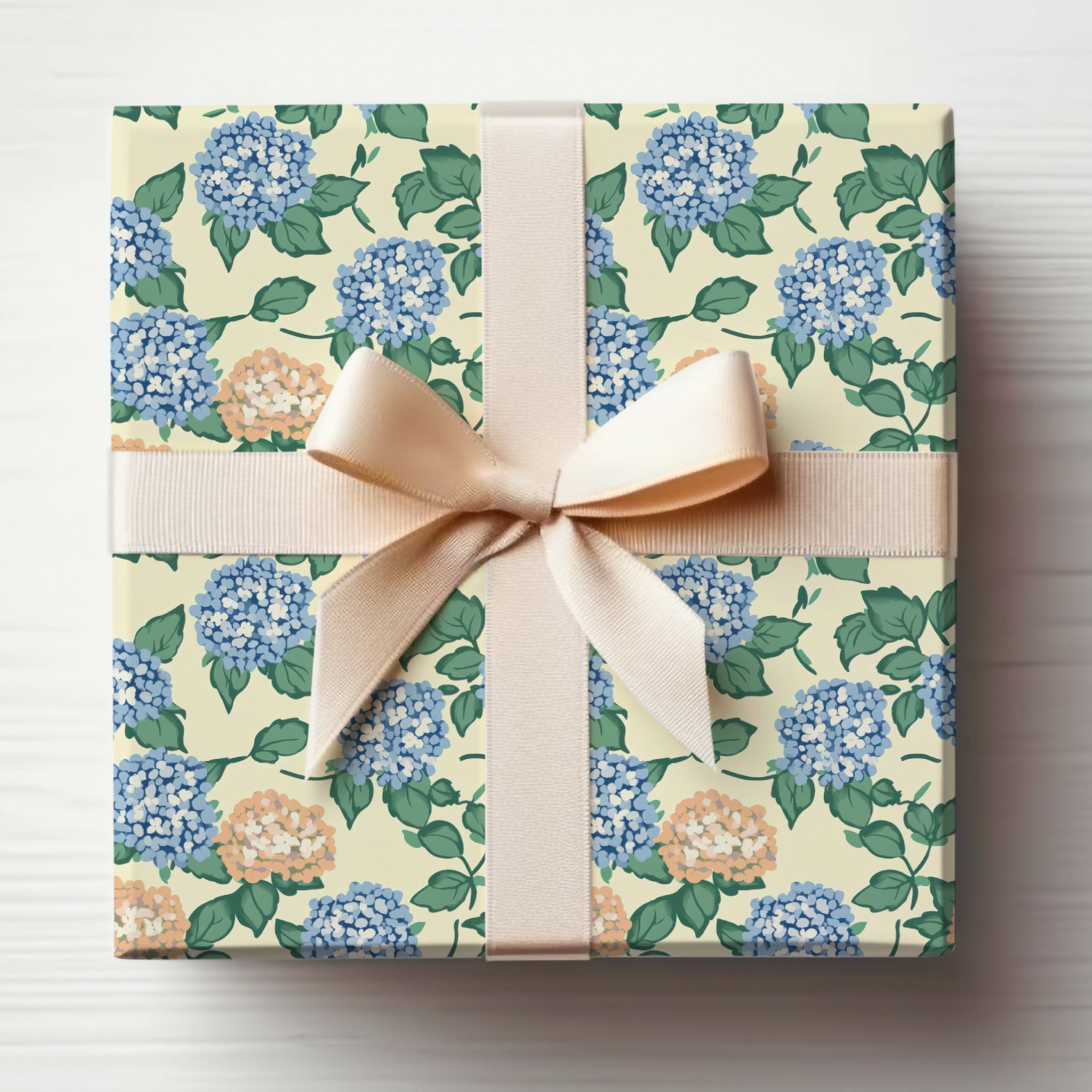 Gift-wrapped box with a floral pattern and a light peach ribbon bow.
