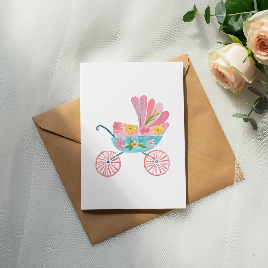Watercolor illustration of a pink and blue baby carriage with floral details.