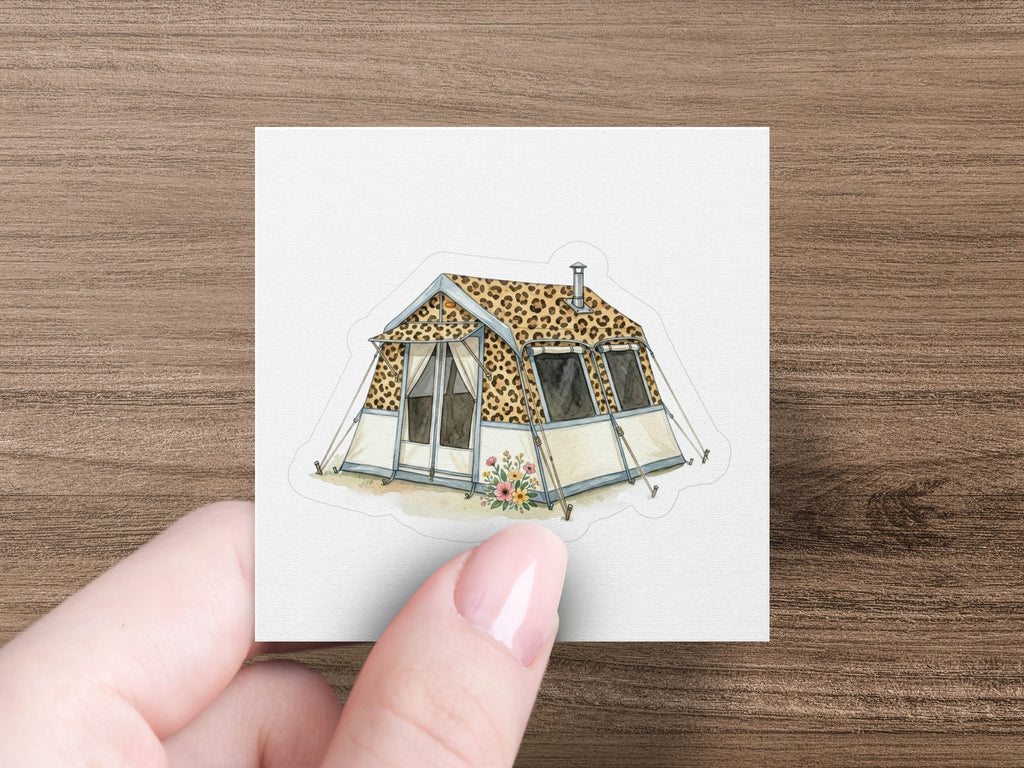 Tent with leopard print fabric and windows, held by a hand.