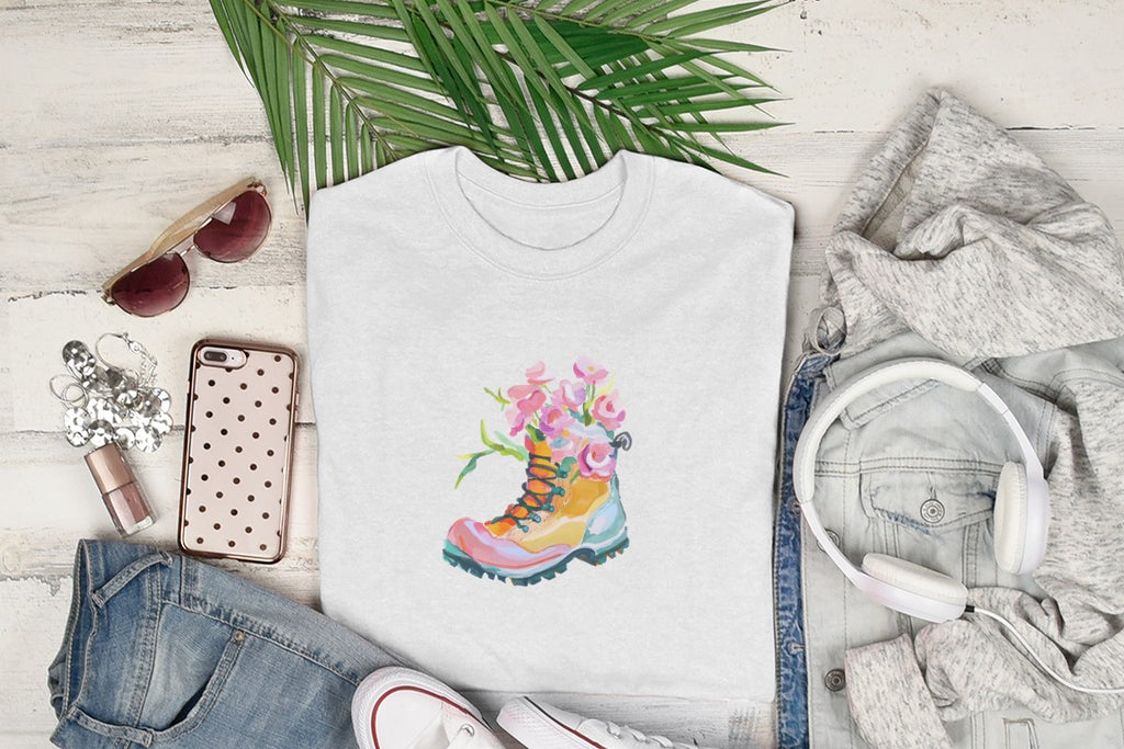 White t-shirt with watercolor hiking boot and flowers design.