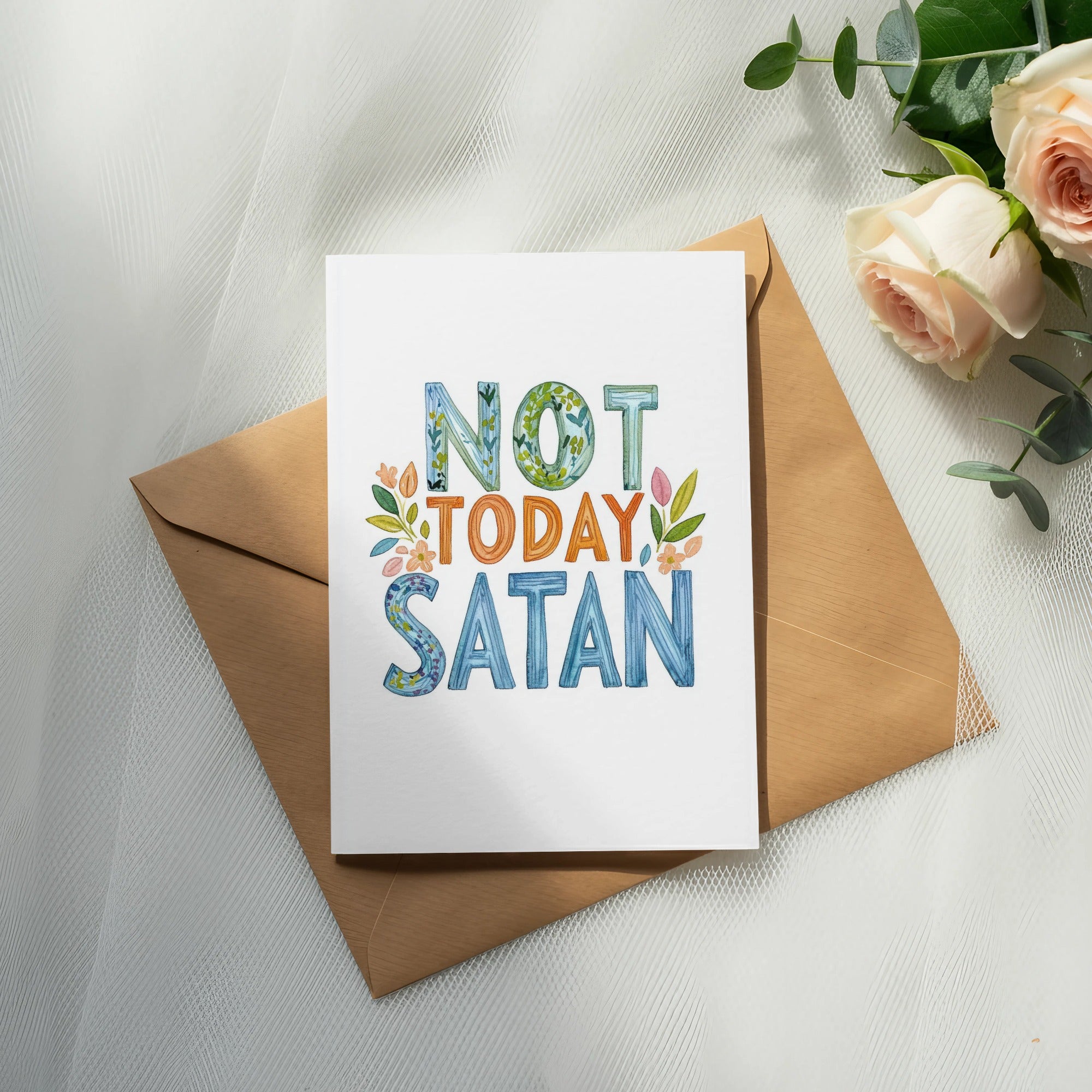Card with "Not Today Satan" text, floral accents, on envelope with roses.
