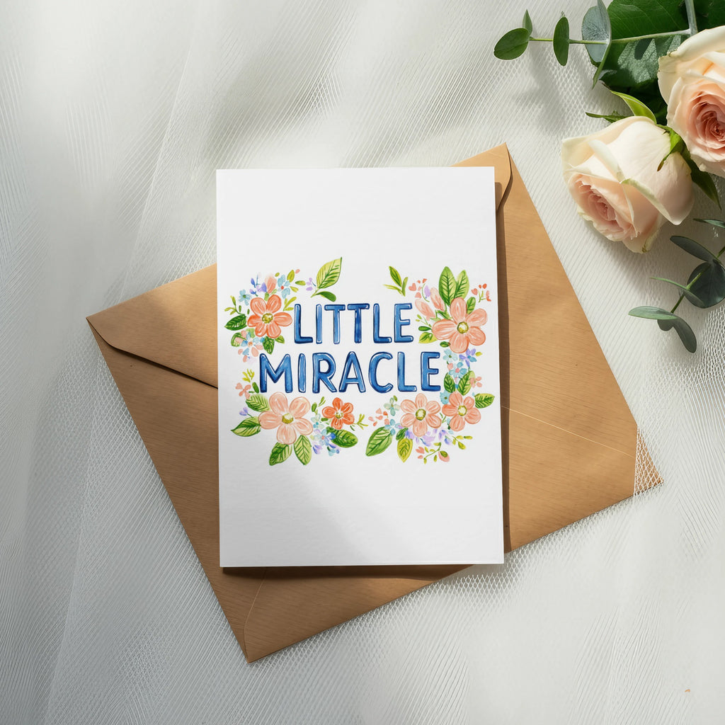 Card with "Little Miracle" text surrounded by watercolor flowers.