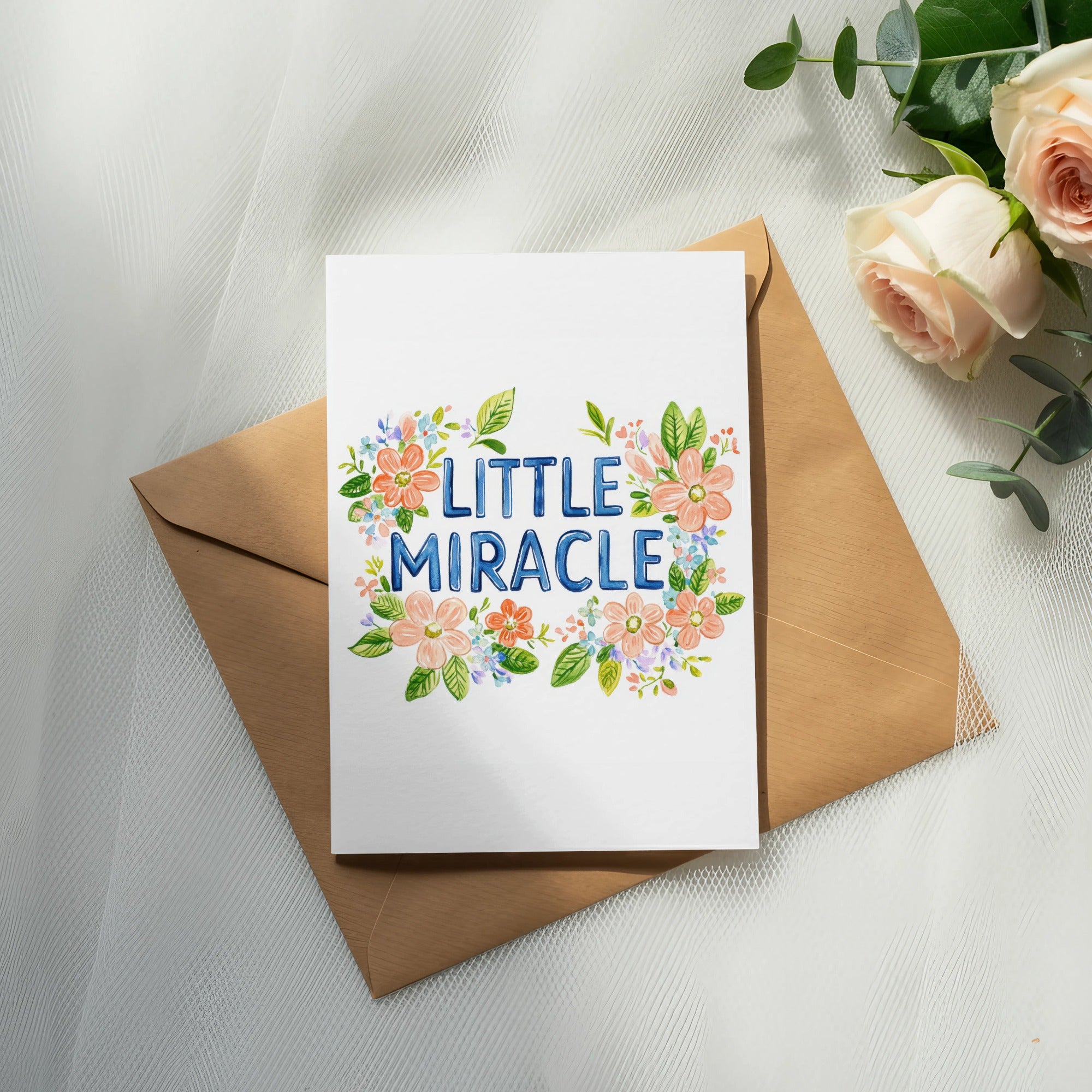 Card with "Little Miracle" text surrounded by watercolor flowers.