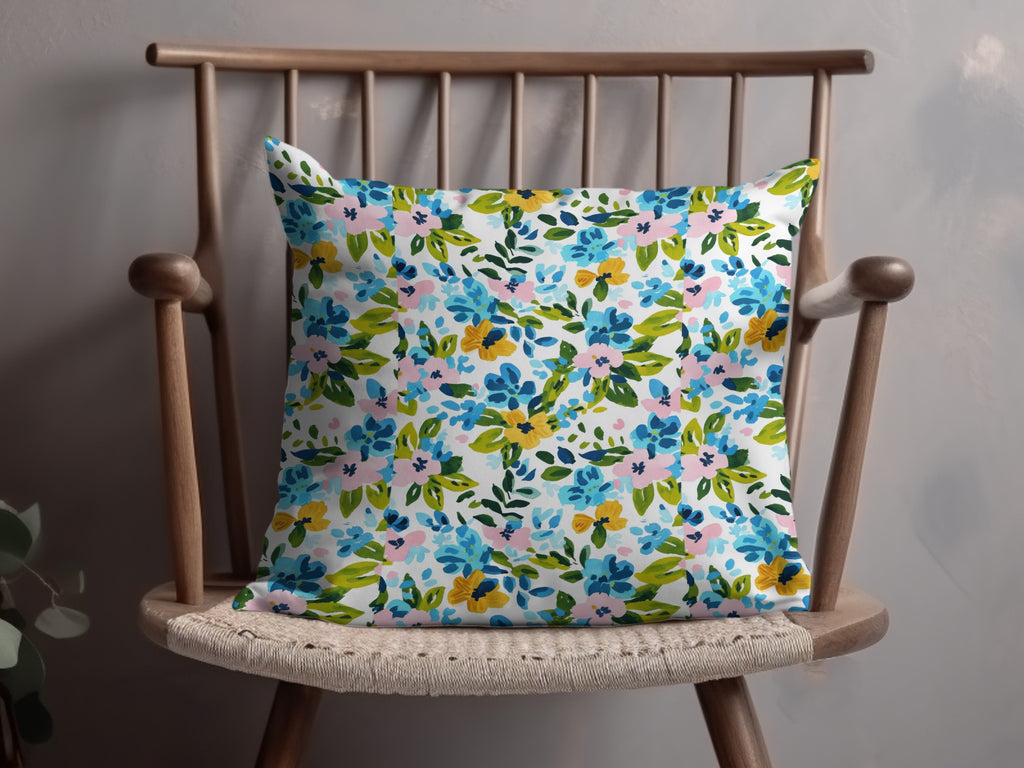 Floral pattern pillow on a wooden chair.